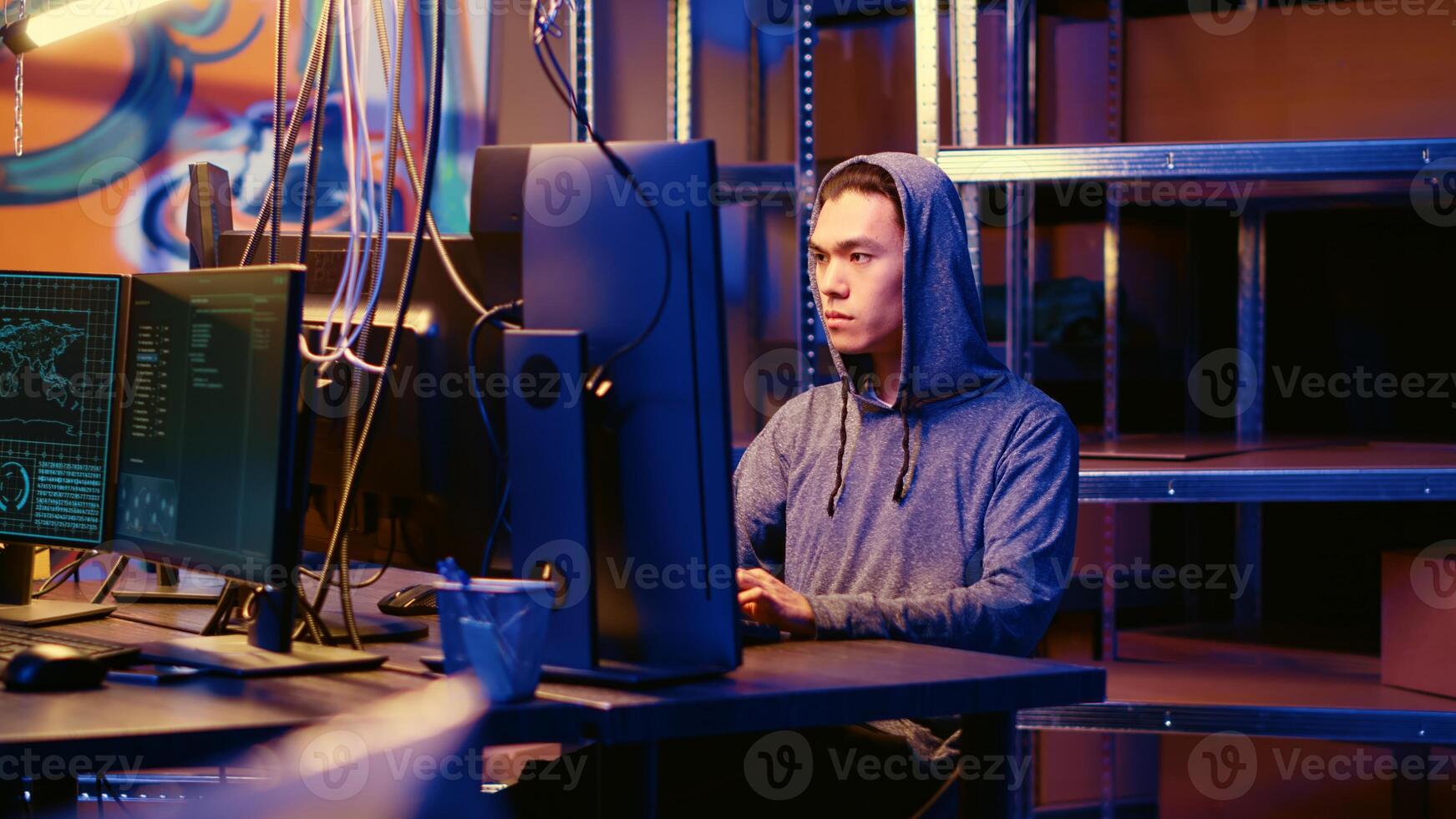 Hacker in graffiti painted underground bunker discussing with colleague about best approach for stealing valuable data using phishing technique, tricking users into revealing sensitive info photo