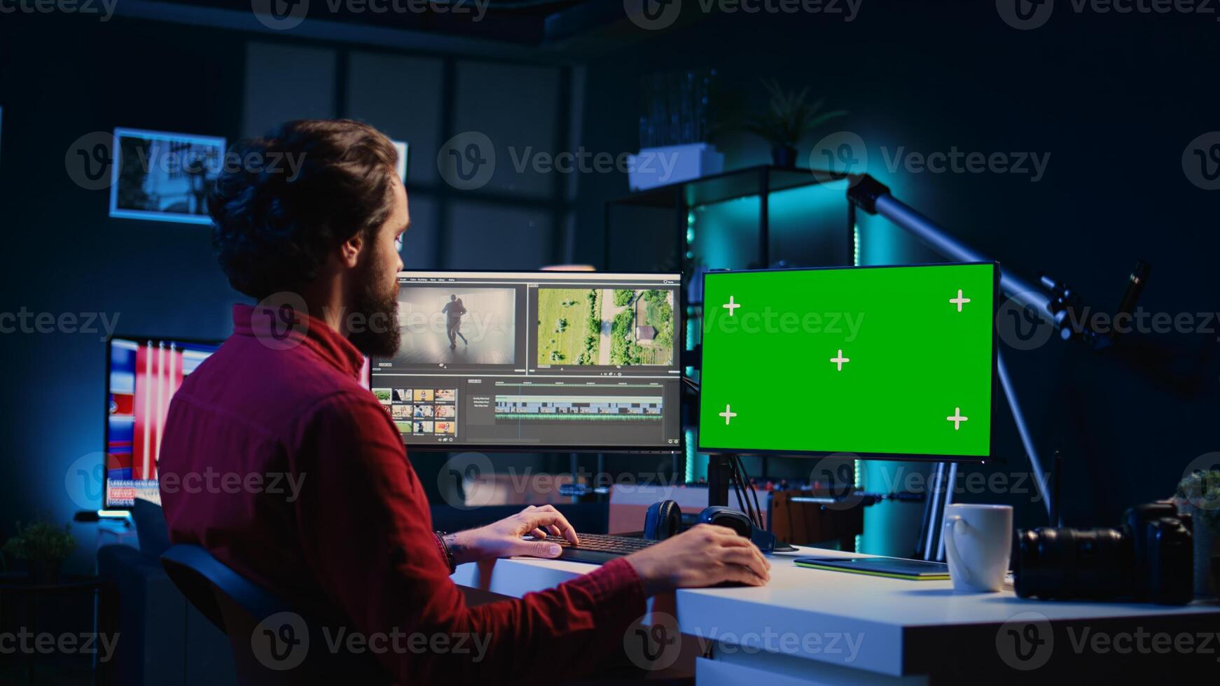 Video editor using editing software on green screen monitor to upgrade footage shot, commissioned by production teams outsourcing tasks. Freelancer videographer finishing project on mockup PC photo