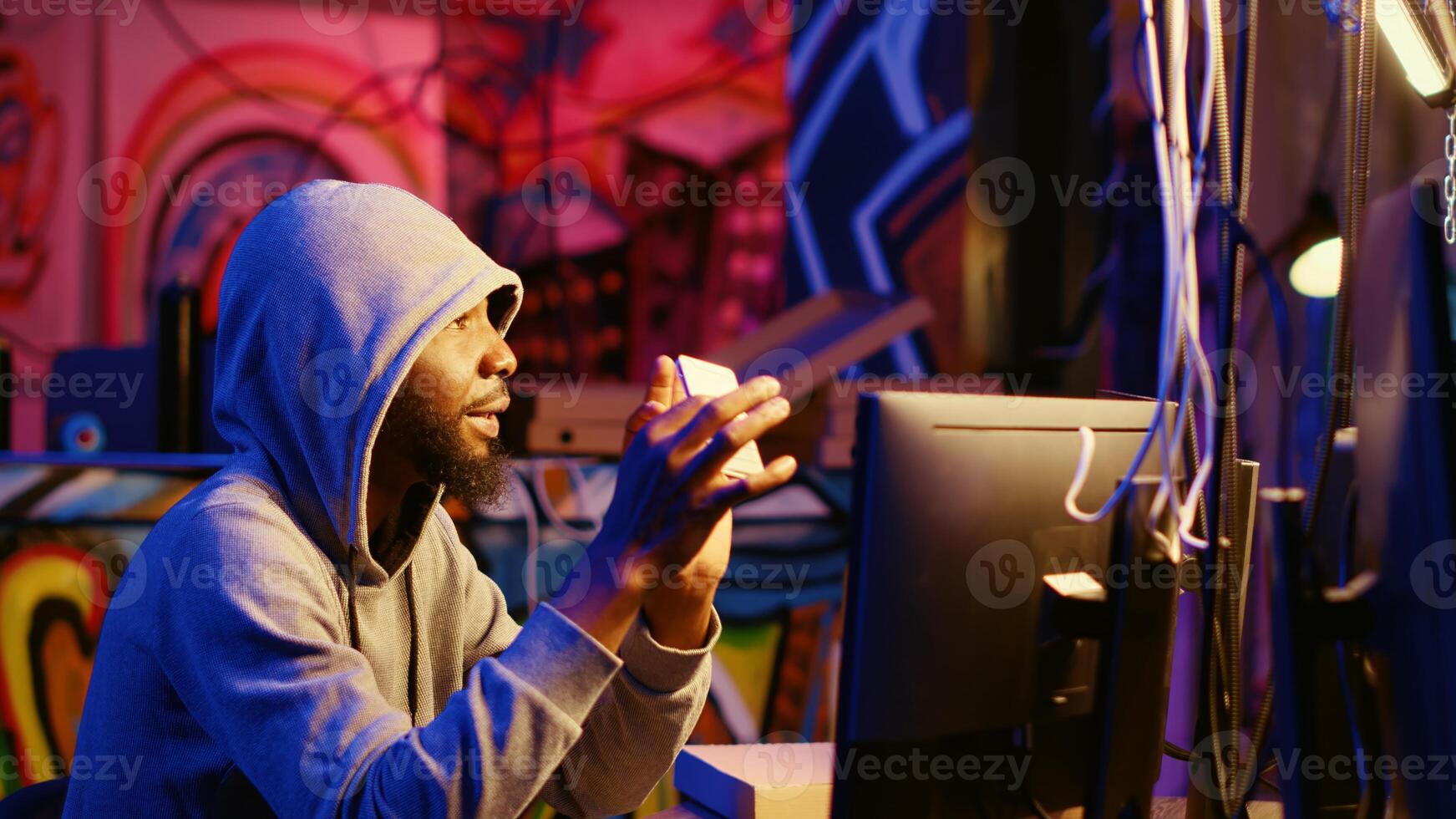 Hacker holding SSD device with valuable information after doing data breaches and financial theft. Cybercriminal with gathered users bank account credentials ready to sell it on black market photo