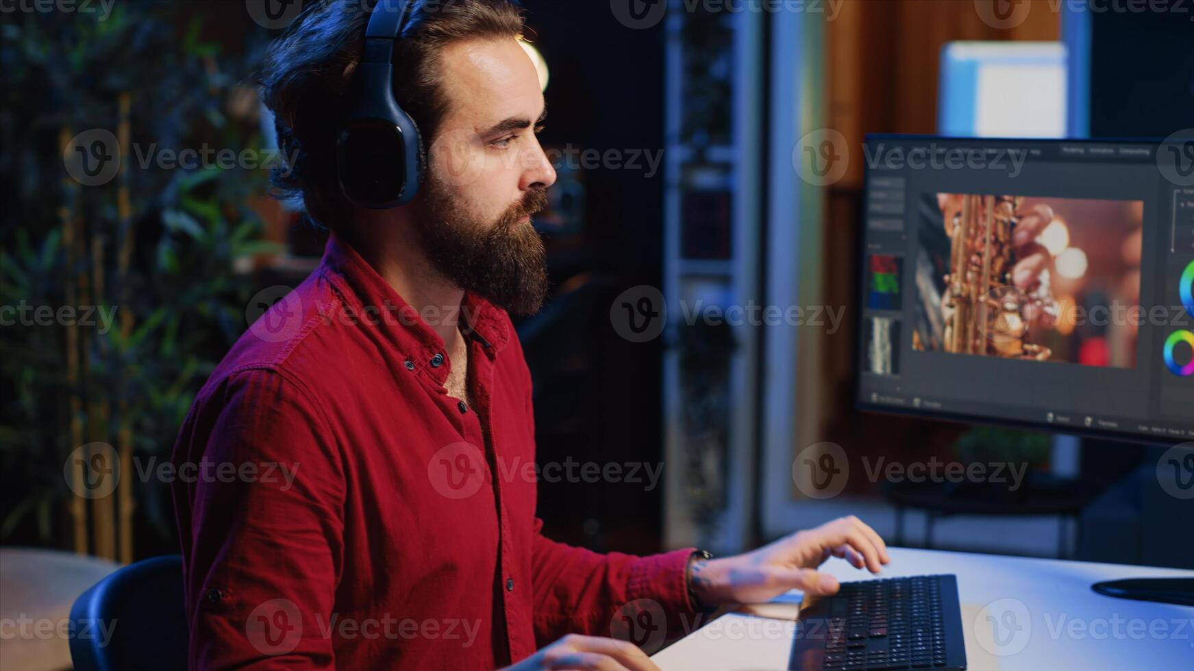 Close up on video editor putting headphones on in order to polish raw footage and improve audio quality. Videographer professionally adjusting clips, applying sound effects to film photo