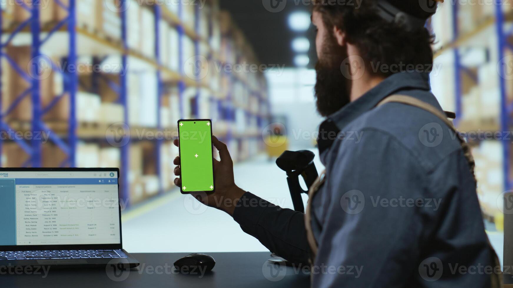 Delivery industrial advisor shows greenscreen display in warehouse storage room, working on cargo logistics for new order shipment. Depot supervisor holds isolated chromakey device. photo