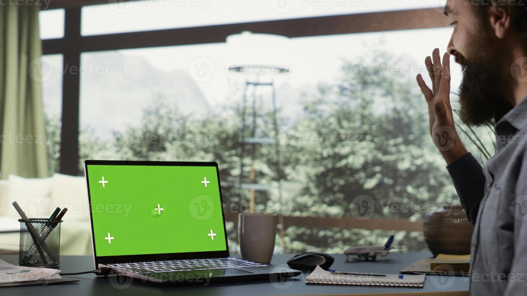 Rich businessman looks at greenscreen on pc, being cozy in his luxurious villa in the woods. Shareholder of multinational company logs onto laptop with isolated chromakey, billionaire lifestyle. photo