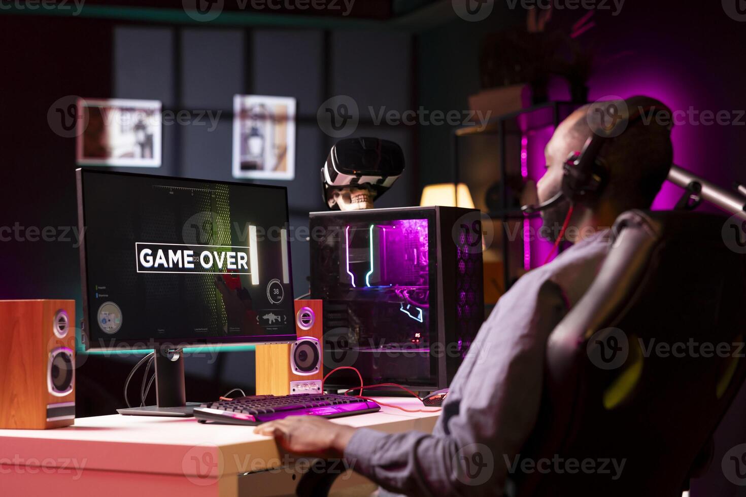 Gamer feeling sad after losing online multiplayer action videogame match, being outsmarted by rival players. Dejected man looking in disheartened manner at game over message on computer screen photo