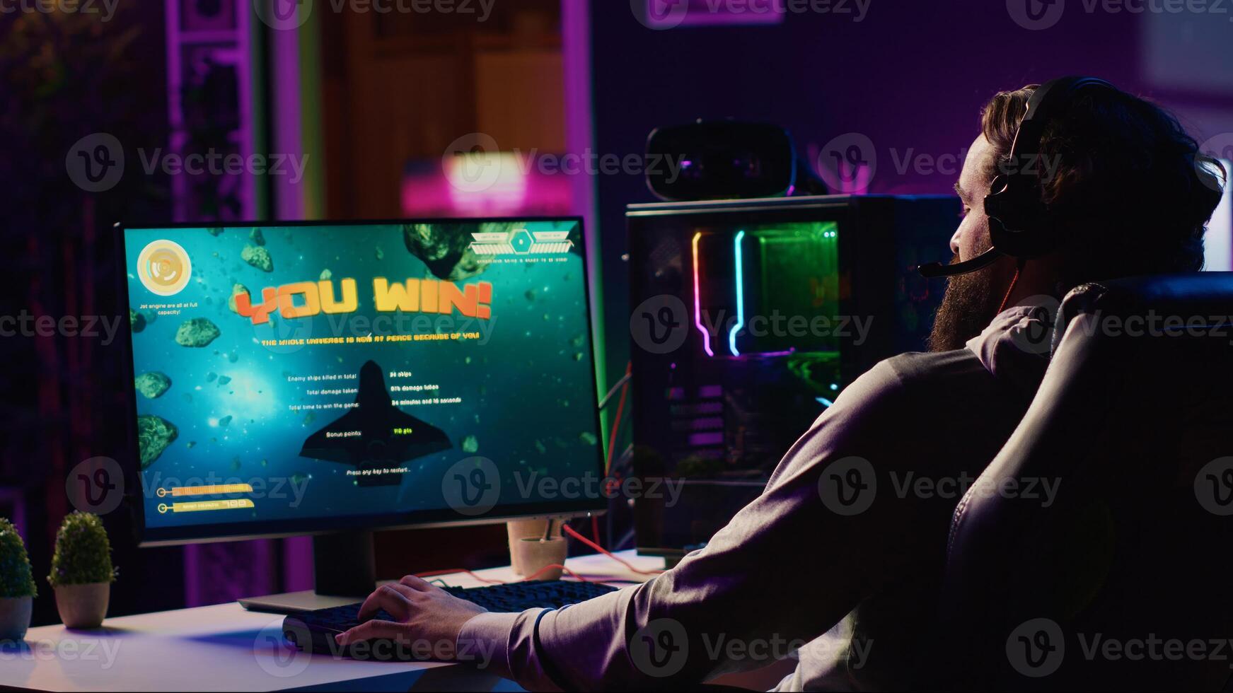 Happy gamer celebrating after destroying all enemy spacecrafts and winning level in science fiction flying game. Cheerful player feeling proud after being victorious in singleplayer videogame photo