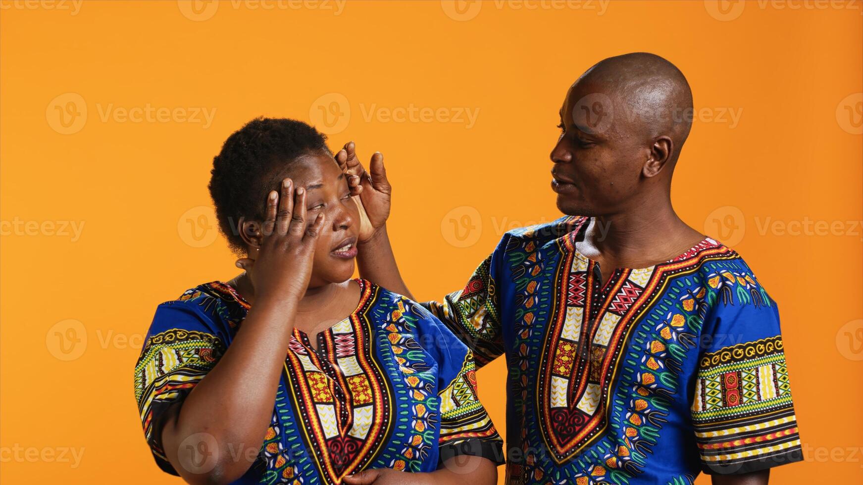 Husband comforting wife with painful headache on camera, dealing with stress and tension. Young man trying to help woman who feels unwell and sick, person rubbing temples to ease migraine pain. photo