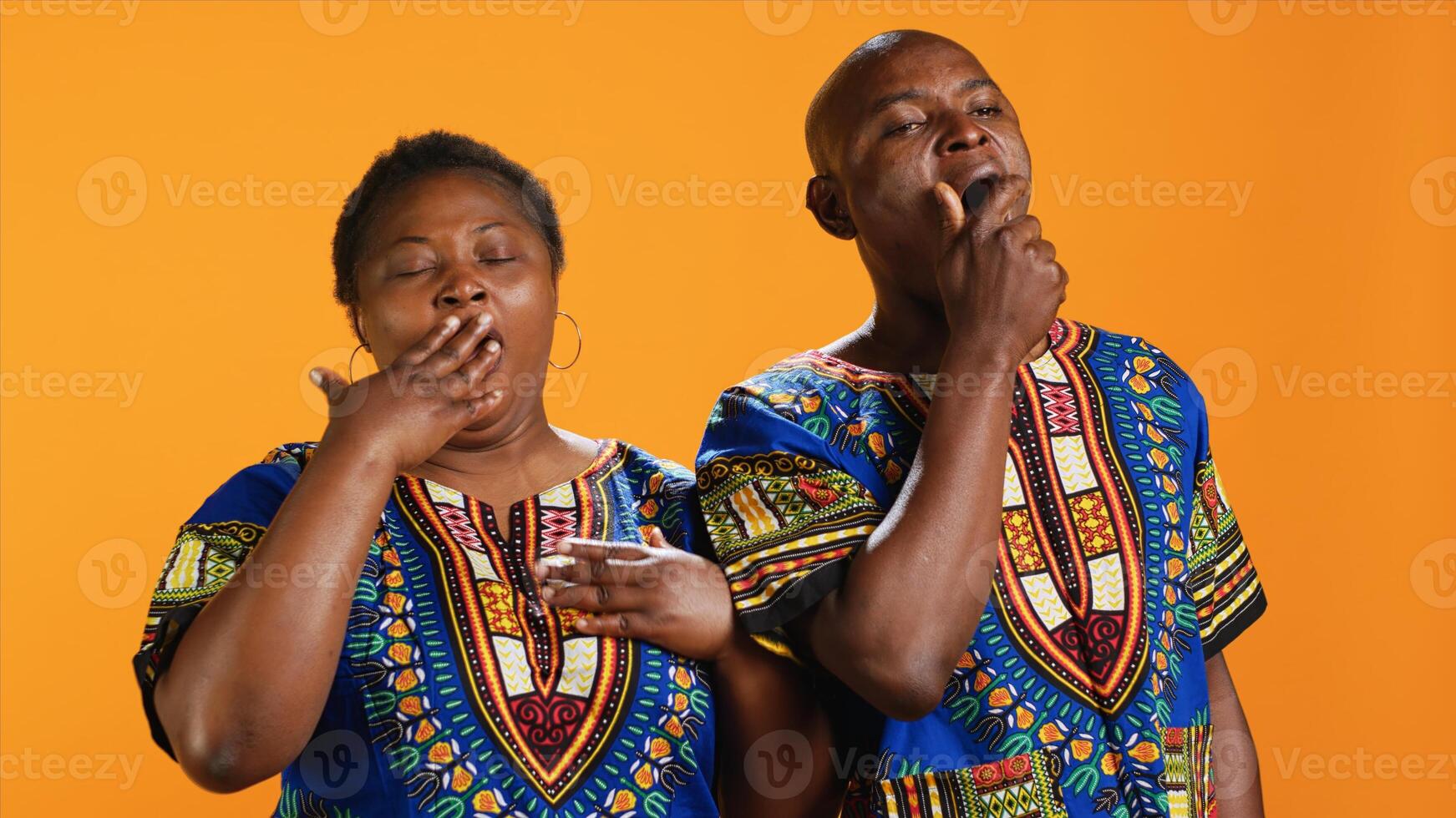 Sleepy african american people yawning in front of camera, feeling extremely tired over orange background. Man and woman being exhausted and dealing with burnout, overworked persons. photo