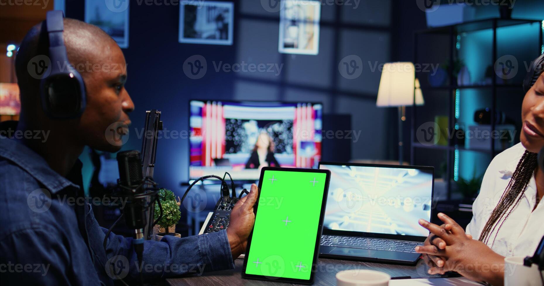 Isolated screen tablet in front of show host recording podcast, enjoying nice conversation with happy guest. Chroma key device in professional studio used for podcasting live session with woman photo