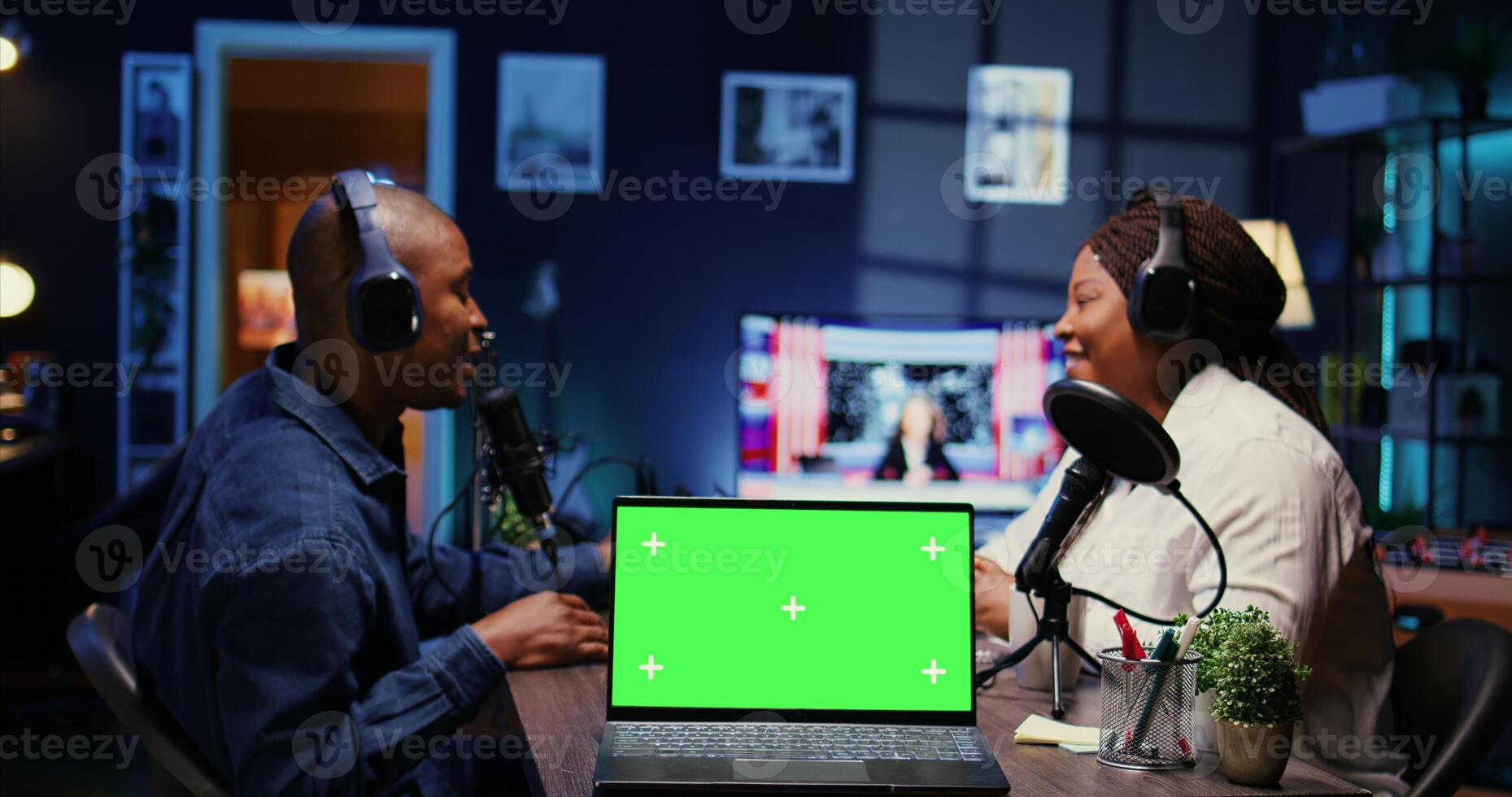 Focus on green screen laptop in front of show host recording podcast, using analog mixer in studio. Mockup notebook and man setting up audio devices in live broadcast for flawless sound quality photo