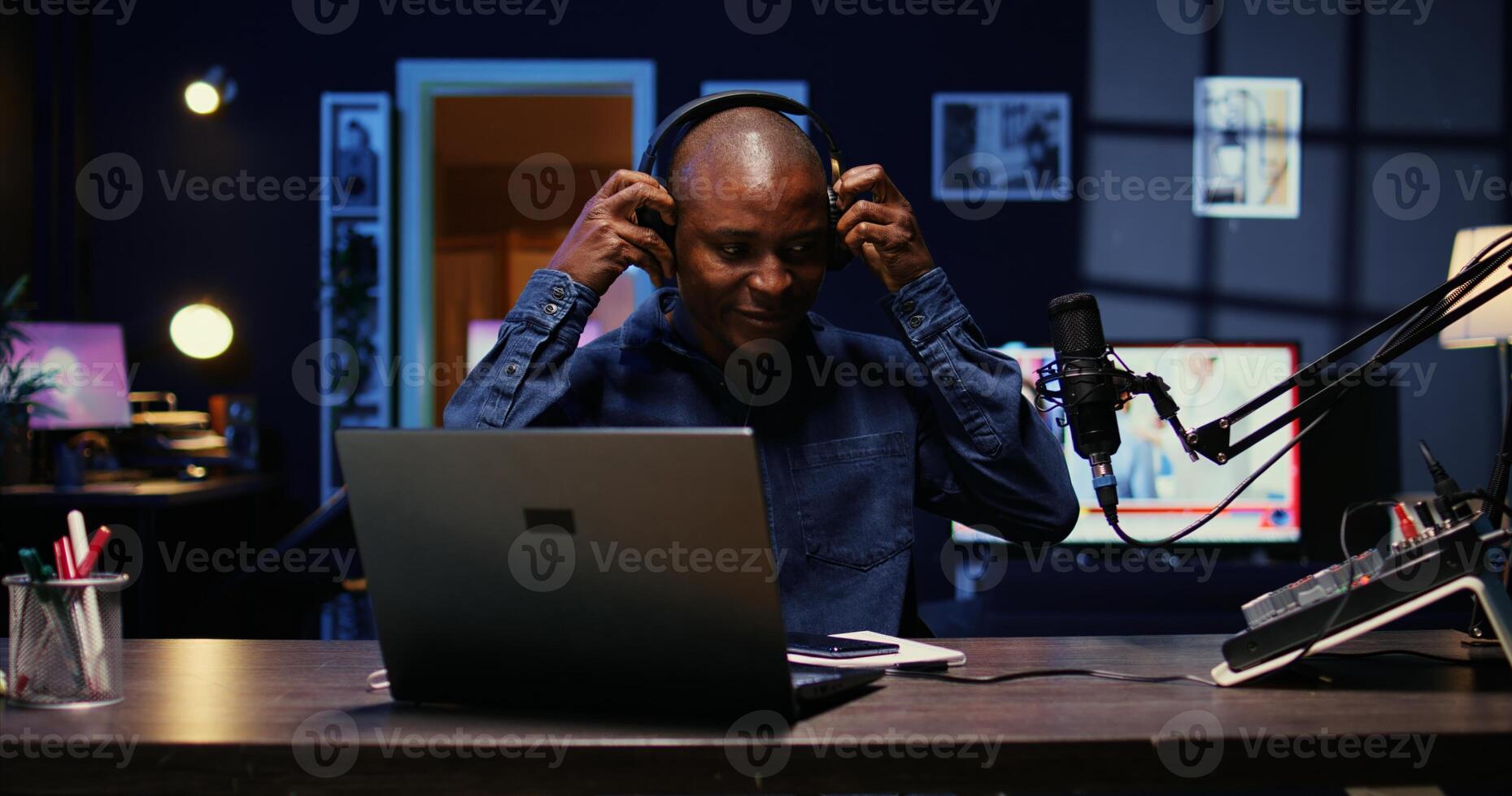 Portrait of african american man starting live broadcast on streaming platform, greeting viewers. Cheerful internet star arriving in studio, ready to create content for his audience photo