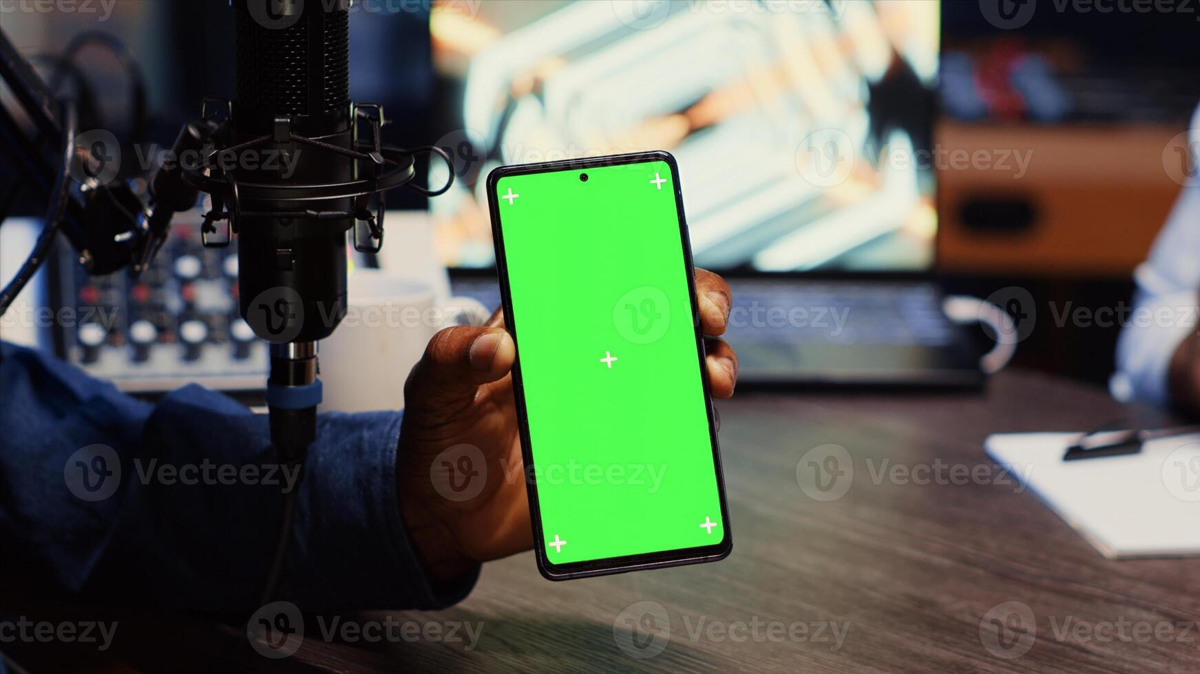Isolated screen smartphone hold by presenter on podcast discussing with guest during marathon stream for humanitarian cause. Mockup mobile phone used by host to check gathered donations from audience photo