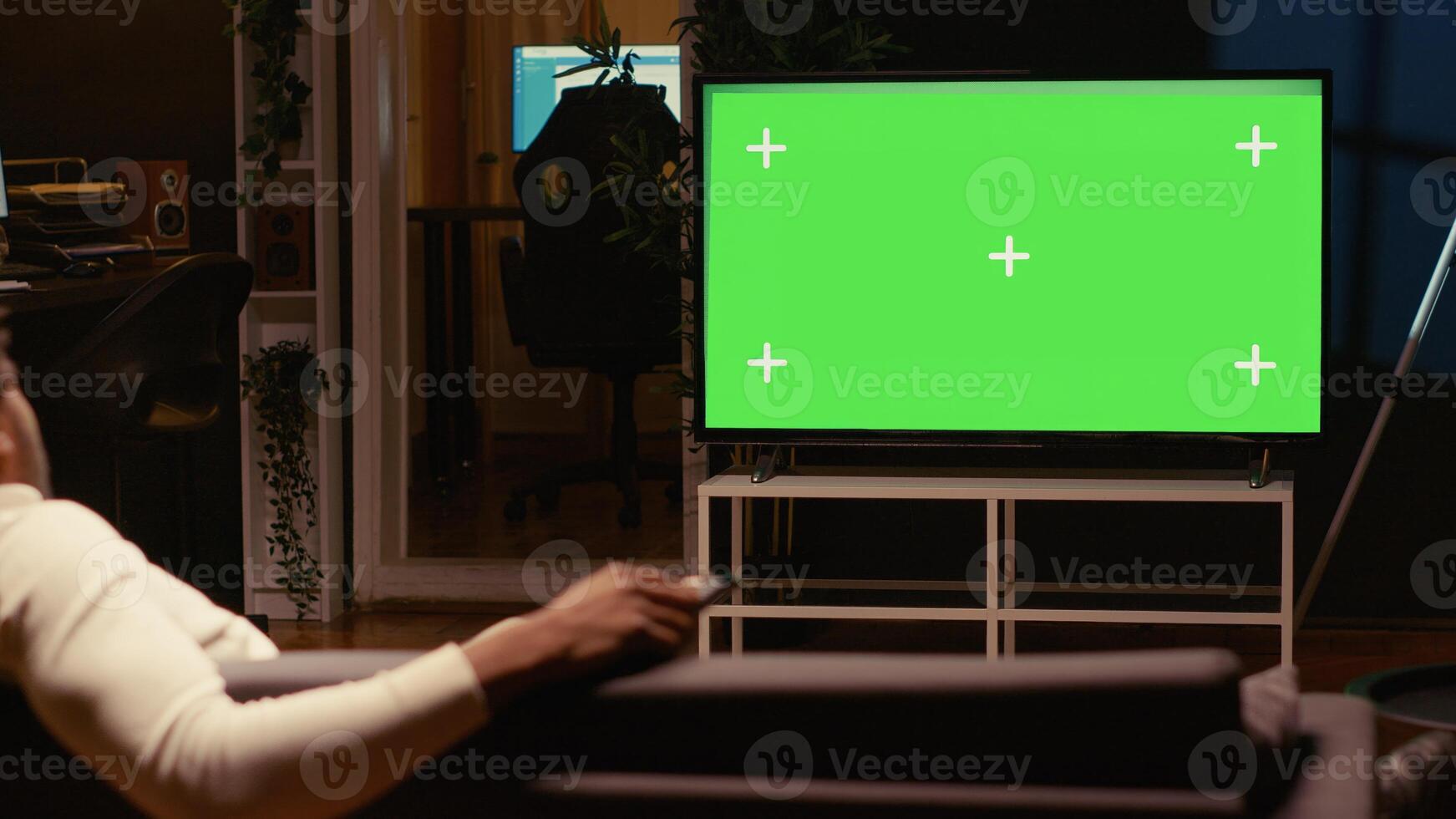 African american man using streaming services on mockup TV to binge watch series from the comfort of his apartment. Person enjoying shows on isolated screen television set during leisure time on couch photo