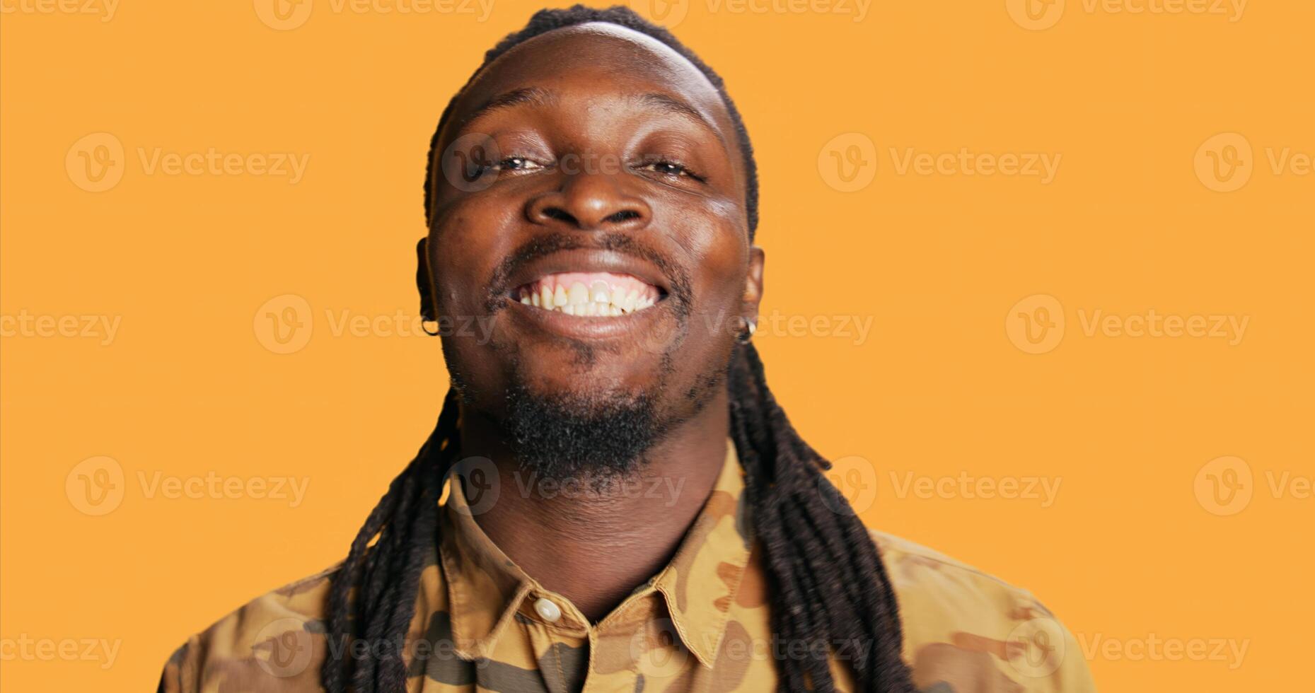 POV of african american man checking his reflection in the mirror, arranging his beard and his hair braids to look attractive and trendy. Cool person is looking at himself and smiling. Tripod shot. photo