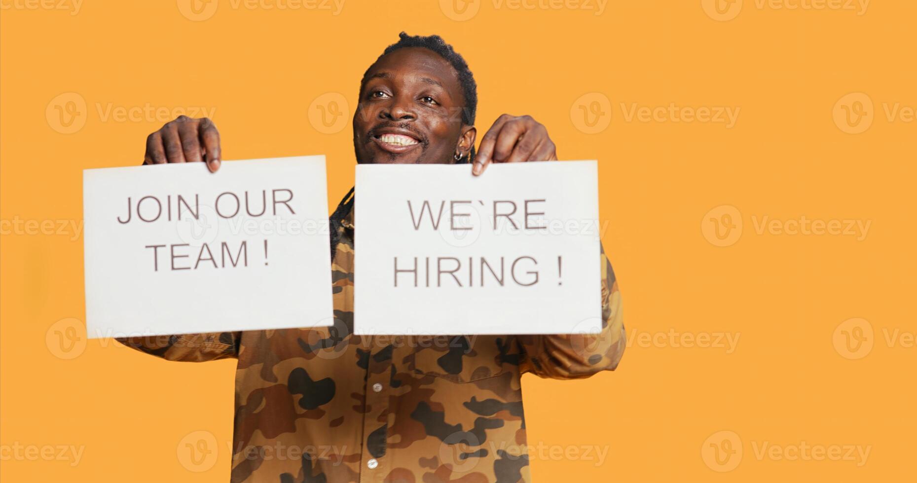 Smiling recruiter showing hiring messages on papers to find new candidates for job vacancy at international company. African american person managing HR recruitments and interviews. photo