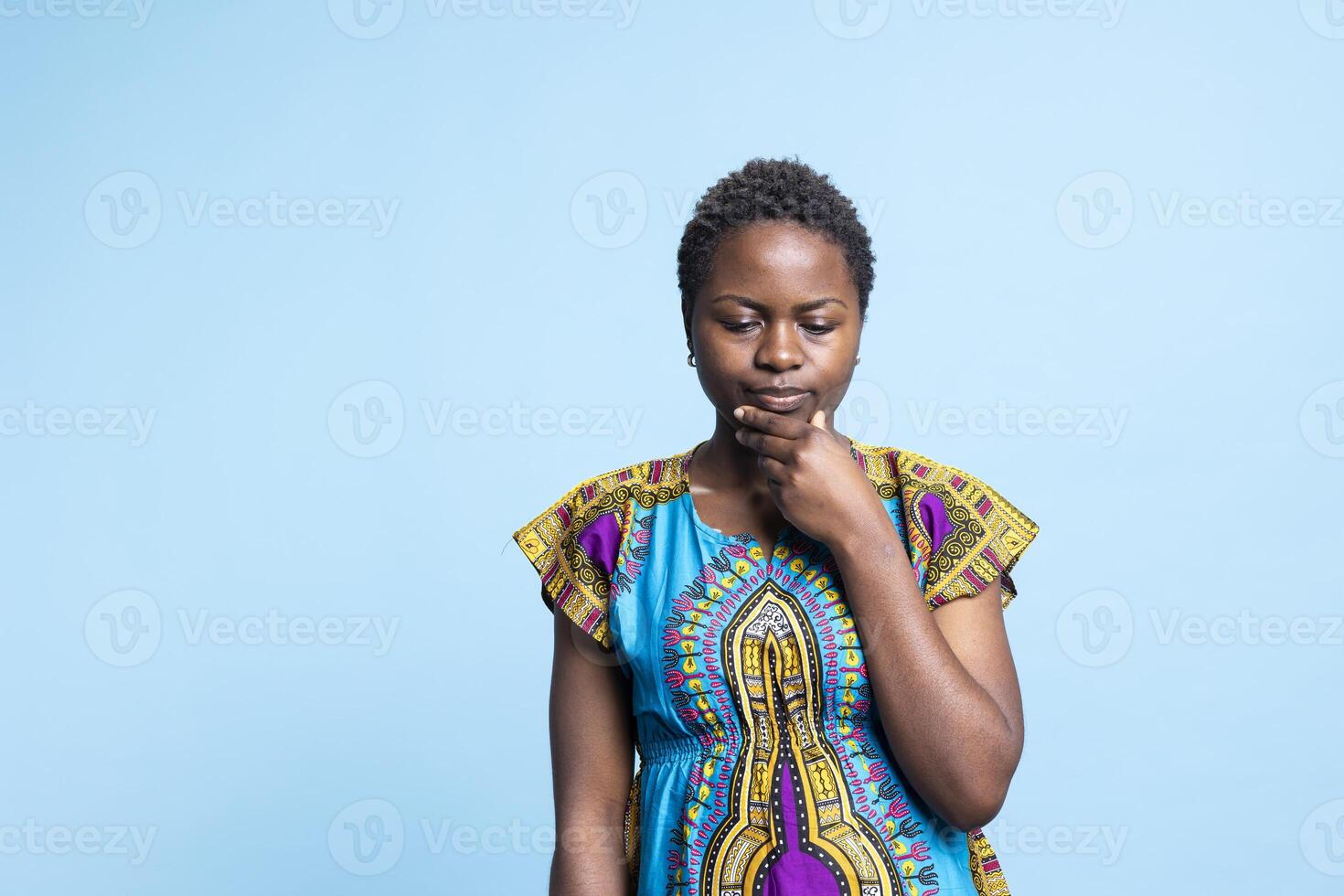 Serious female model posing with a meditative facial expression, African american doubtful girl contemplating about something. Young person thinking about new ideas, confusion concept. photo