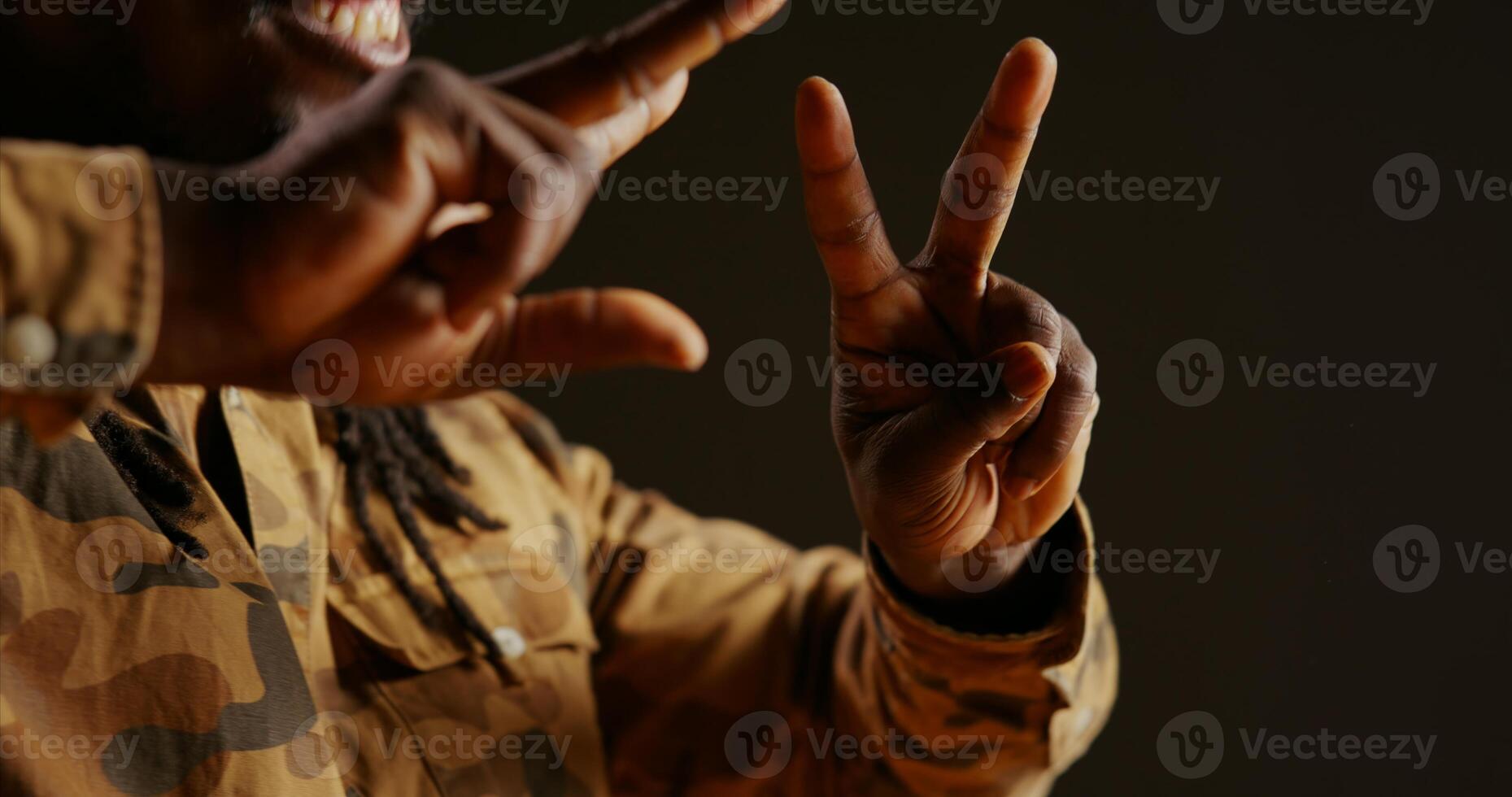 Male model showing heart shape sign on camera, presenting his love and sincere feelings. Young adult smiling and doing romantic symbol, being flirty and sweet. Handheld shot. Close up. photo