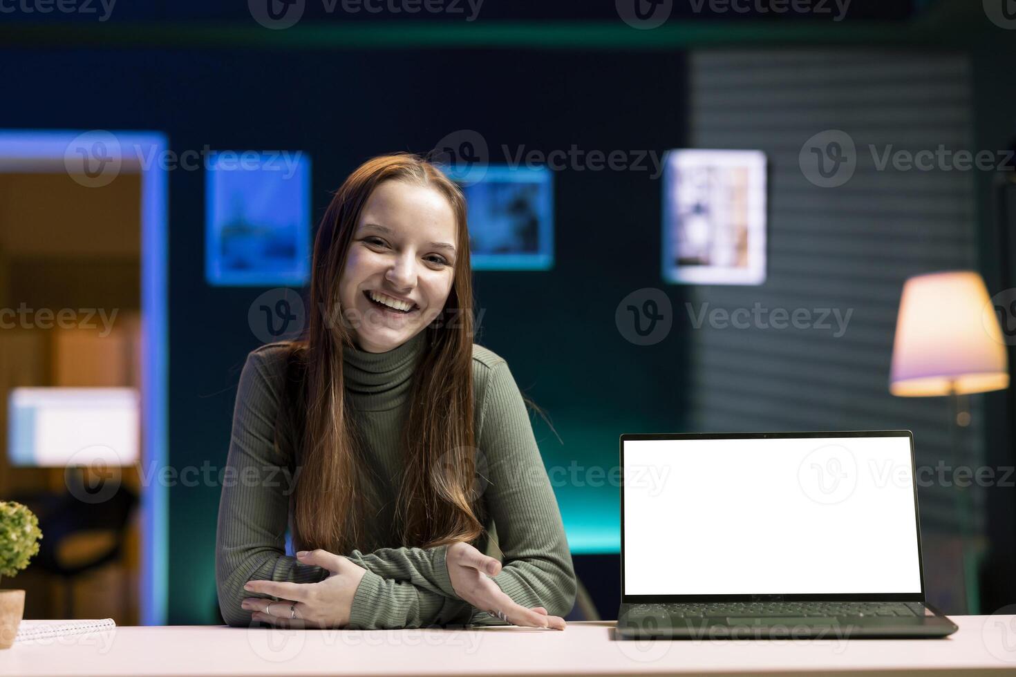Happy young tech expert presenting mockup laptop in entry level low budget price range. Cheerful gen Z content creator reviewing isolated screen notebook in front of internet fanbase photo