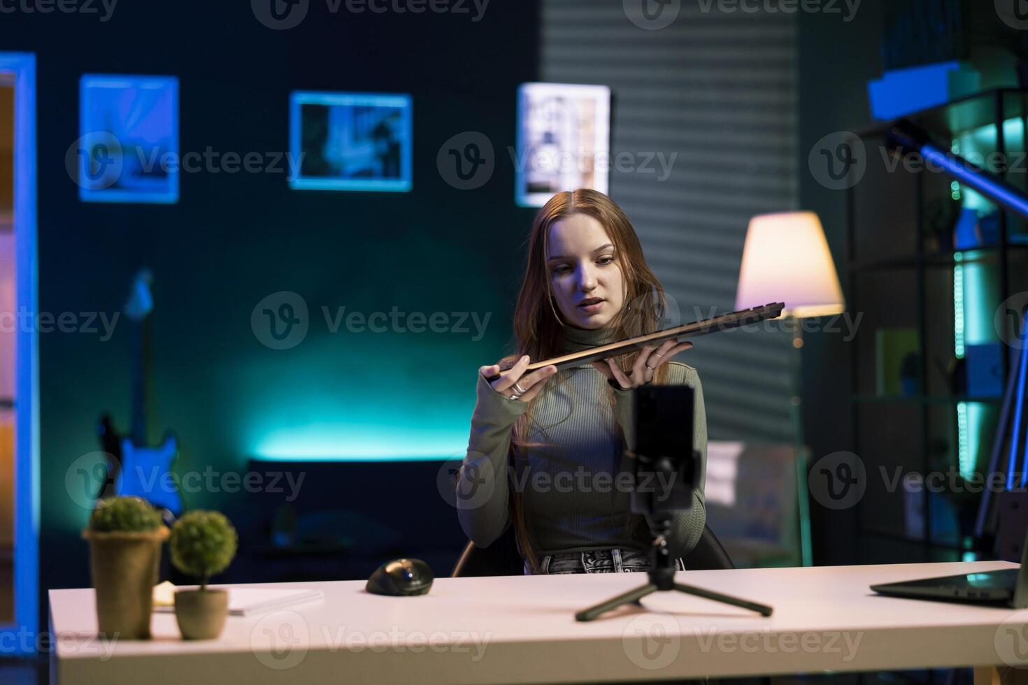 Gen Z entertainer presenting keyboard from brand sponsoring video, urging fans to buy it. Young media star does influencer marketing by advertising computer peripherals to audience in studio photo