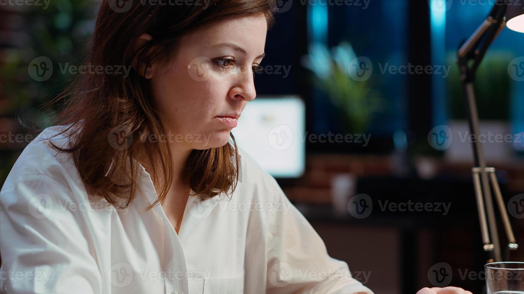 Close up shot of staff member in office late at night typing on laptop keyboard, doing tasks in office overnight. Employee inputting data for company project at computer desk photo