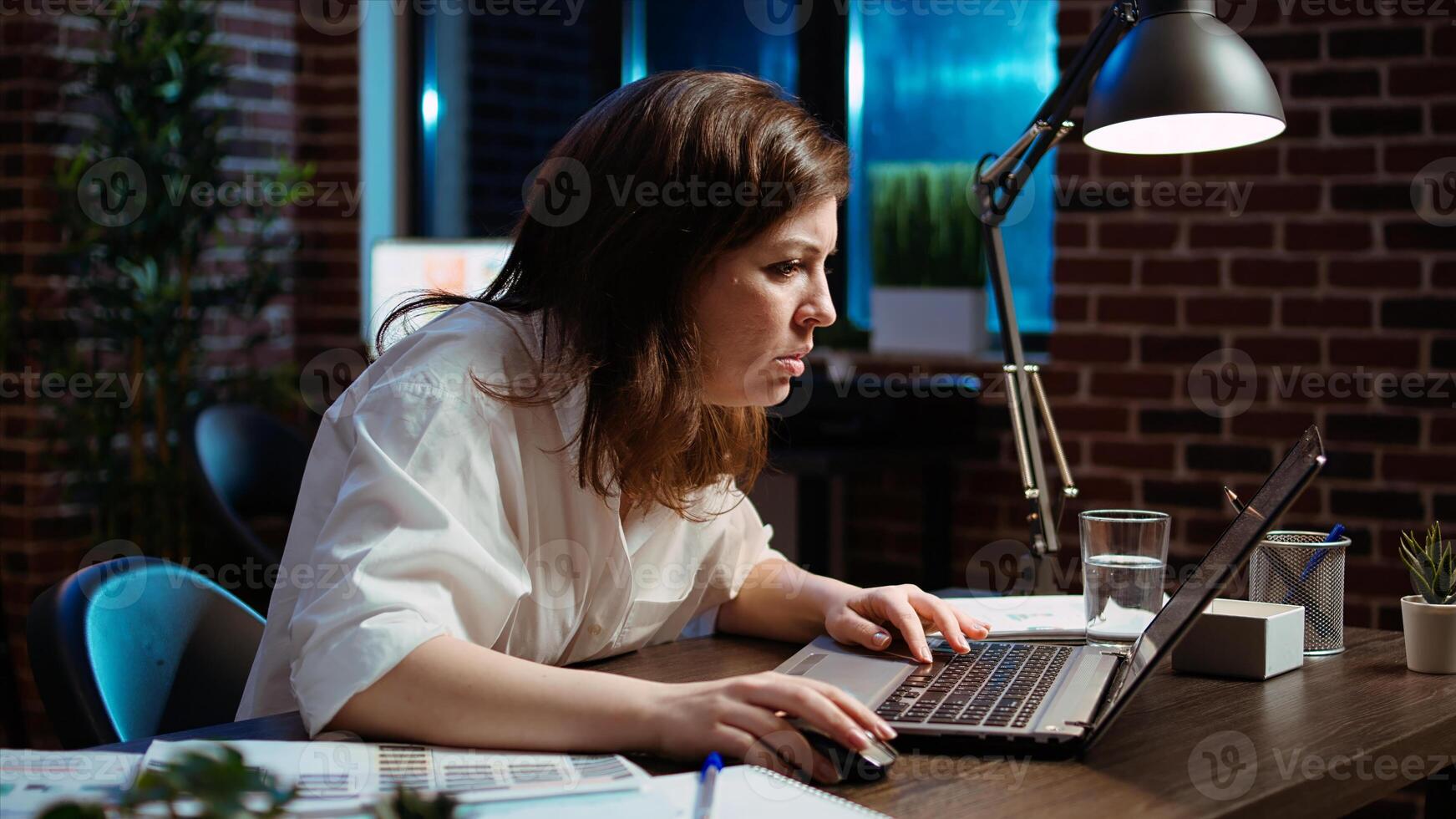 Employee upset by negative response received from customer while discussing business matters over email messages. Worker exasperated, putting head in head, frustrated by too much work in office photo
