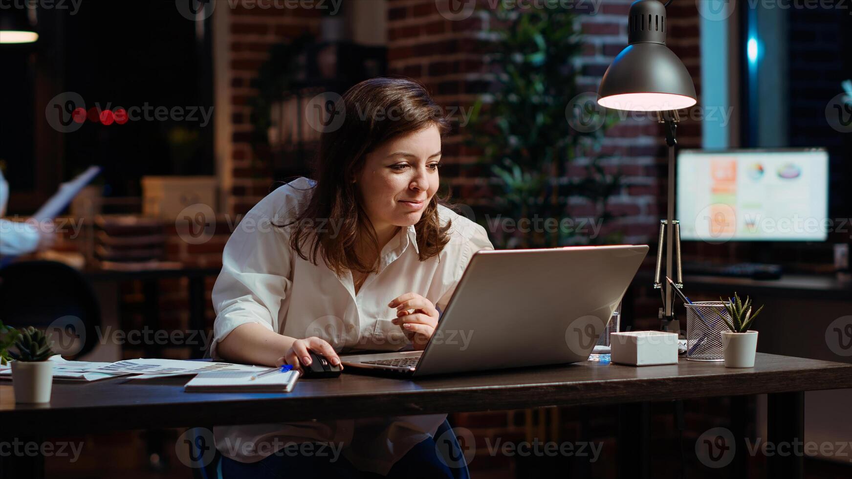 Woman in office celebrating finalizing deal with business partners, happy about incoming salary bonus. Employee in workplace dancing on chair after closing agreement with B2B clients, camera B photo
