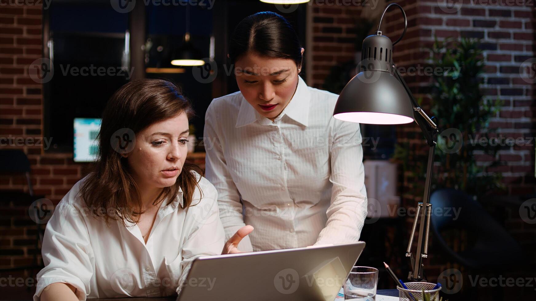 Worker brainstorming with colleague to write email at computer desk, finalizing deal with business partners. Coworkers using laptop to make agreement over internet with associates, zoom in shot photo