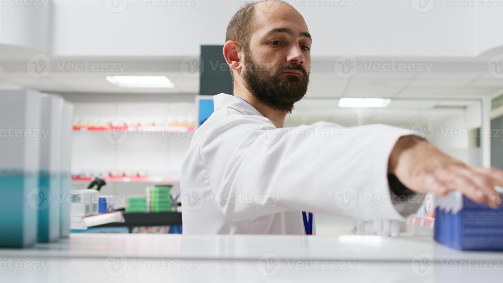 POV of retail clerk taking medical products off of shelves, putting all types of medicaments in a basket to restore. Healthcare assistant working on reorganizing pills or prescription drugs. photo