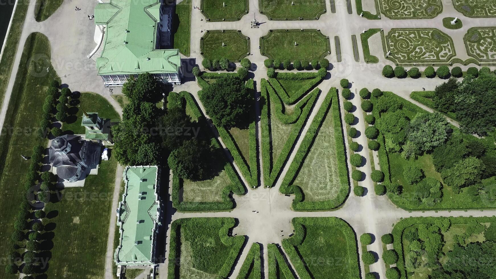 Top view of royal garden with patterns and ancient buildings. Creative. Amazing beauty of garden pattern and trails of royal palace. Territory of old rich estate with garden on sunny summer day photo