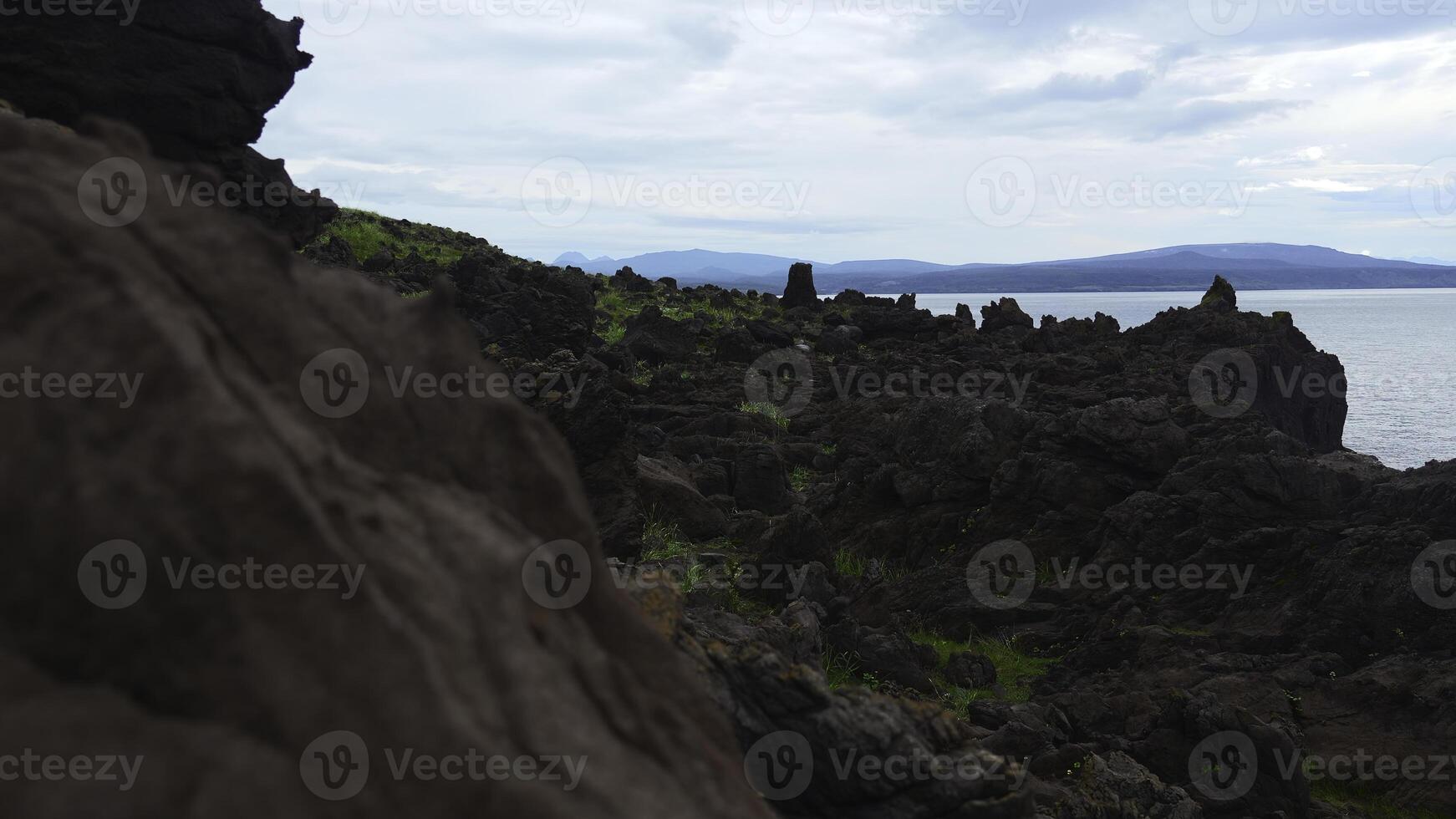 Amazing landscape with rocks and rocks of sea. Clip. Cosmic nature of stone coast of sea. Fabulous landscape of amazing stone coast with sharp rocks by sea. Wonders of earthly nature photo