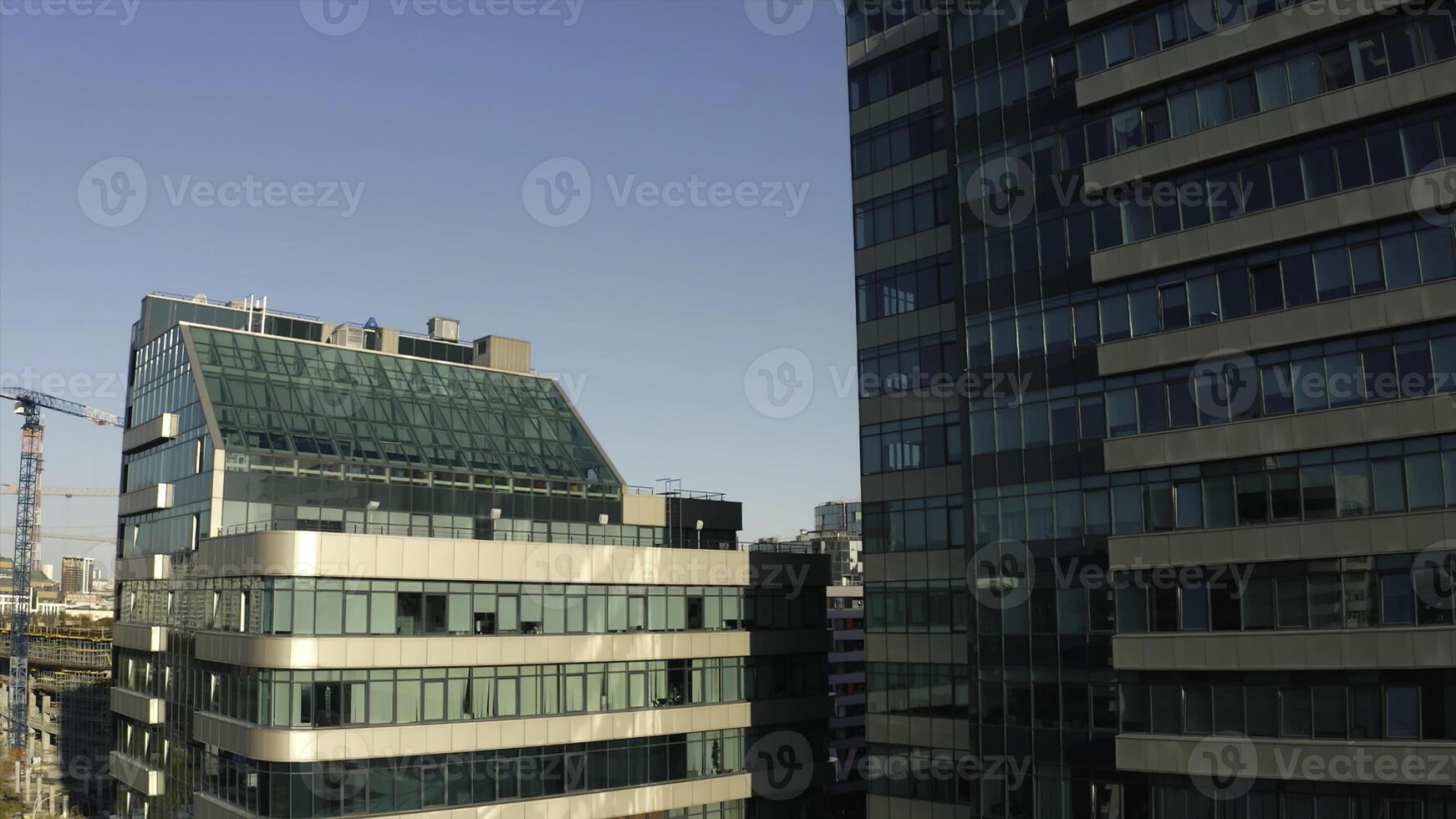 Top view of facade of beautiful glass skyscrapers. Stock footage. Beautiful glass skyscrapers in sunny summer day. Beautiful architecture of glass skyscrapers in center of modern city photo