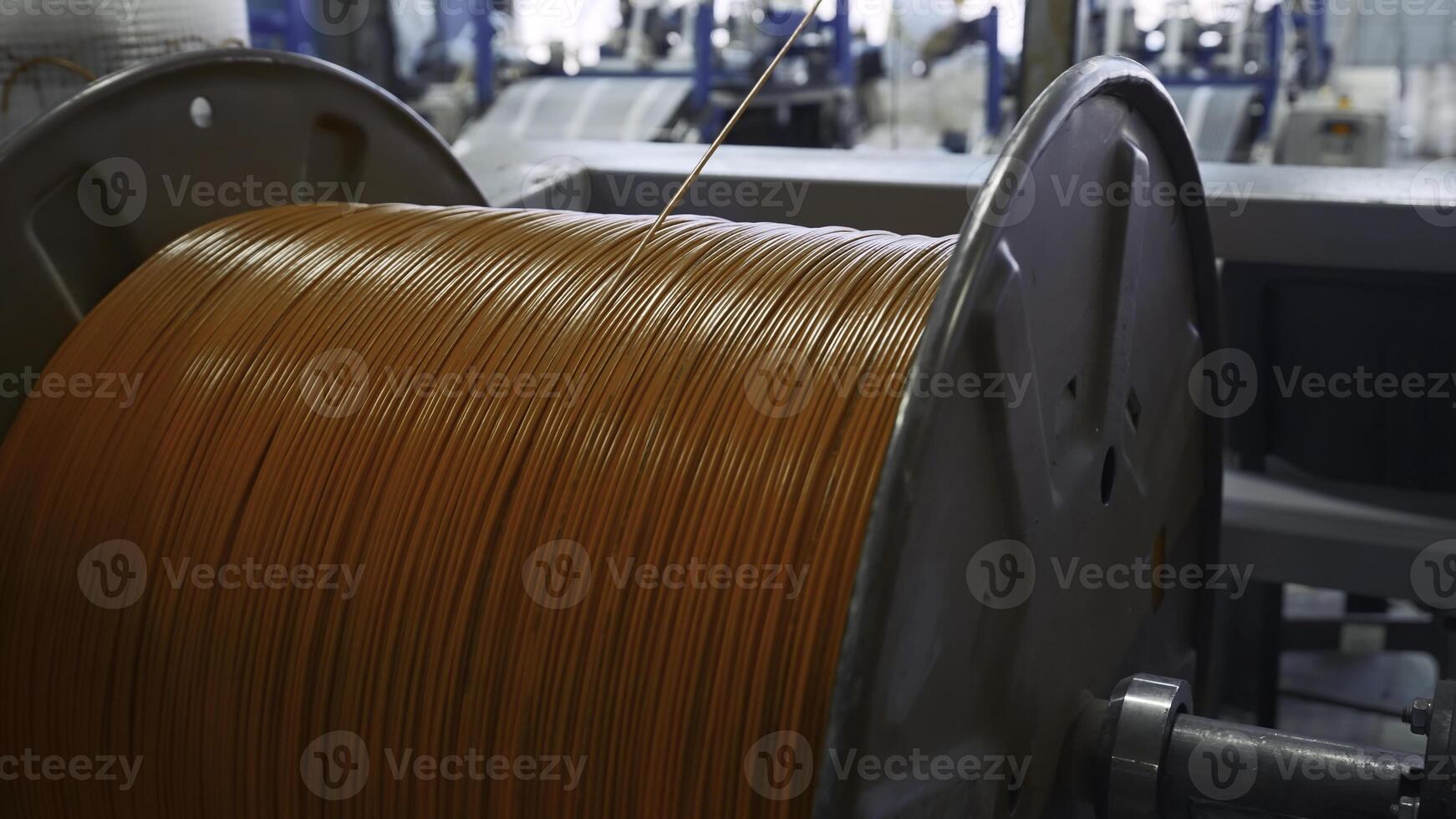 Spinning reel with rubber wire. Creative. Unwinding coil with rubber wire for insulation. Industrial production with rubber wires photo