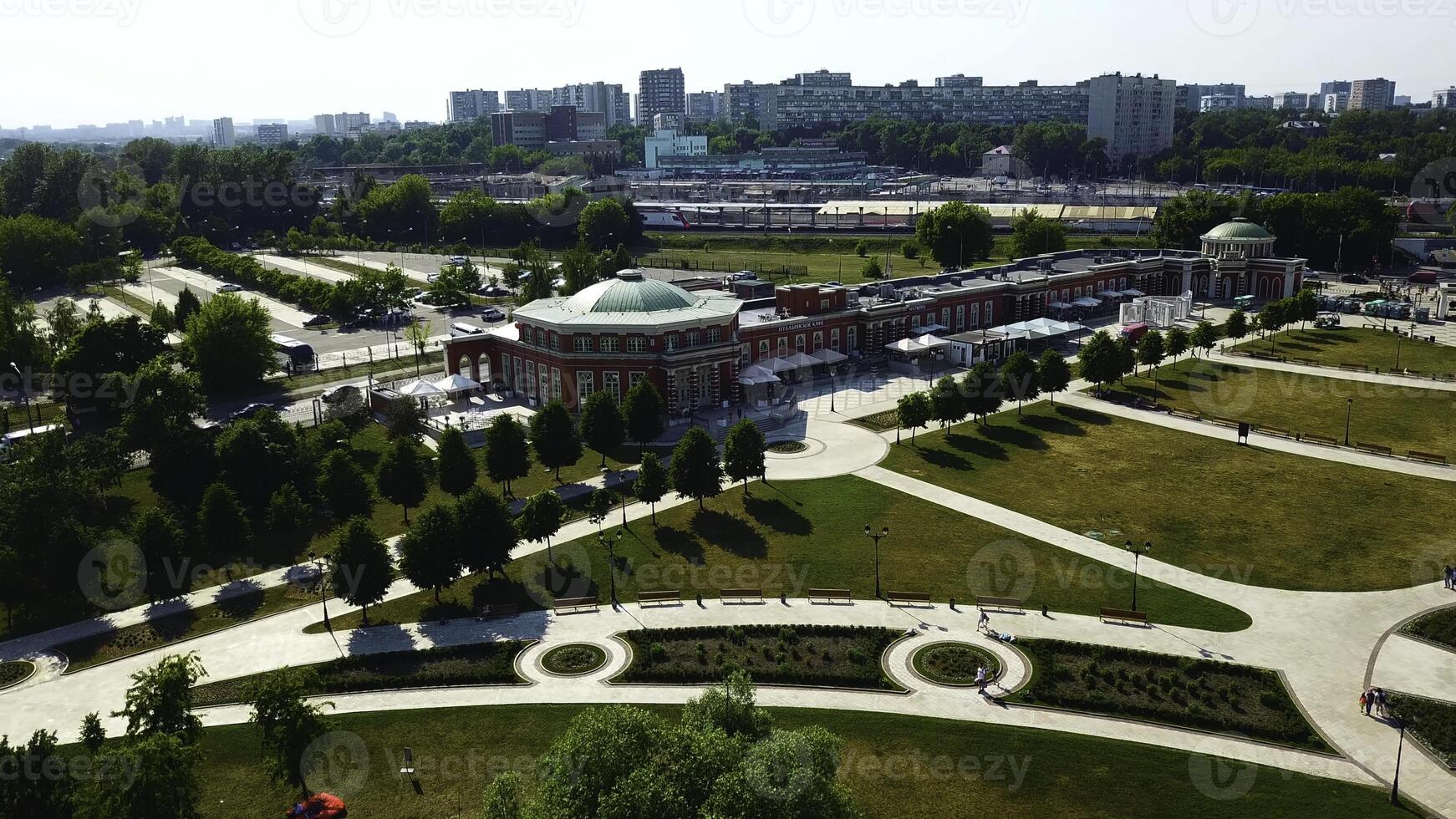 Top view of historic building with garden patterns on sunny day. Creative. Landscape design of garden with patterns near historic building. Historical complex with garden on background of modern city photo