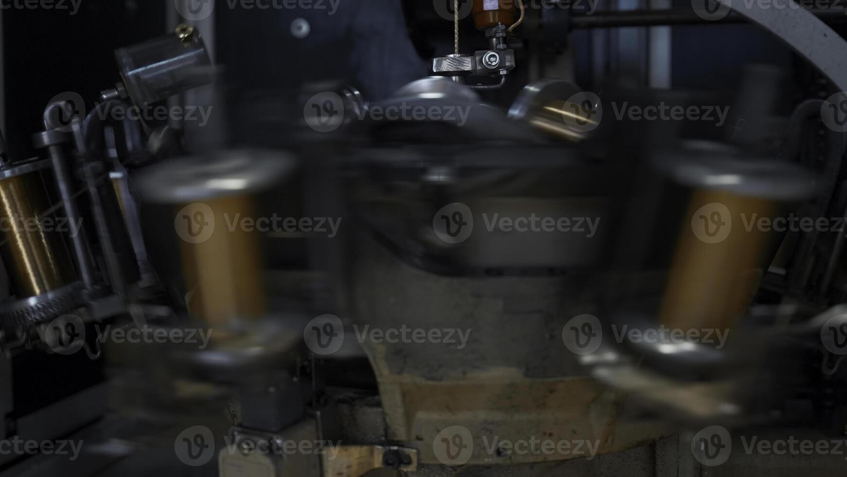 Coils with copper wire rotate on machine. Creative. Rotating coils of copper wire on industrial machine. Metallurgical plant with automated equipment for wire production photo