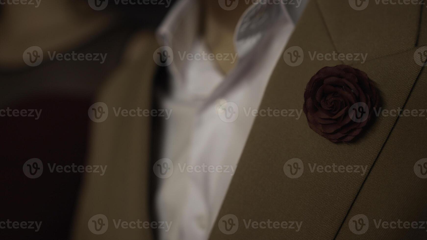 Close-up of man in suit with brooch. Stock footage. Man in beautiful stylish suit with brooch. Elegant retro suit on man with red rose brooch photo