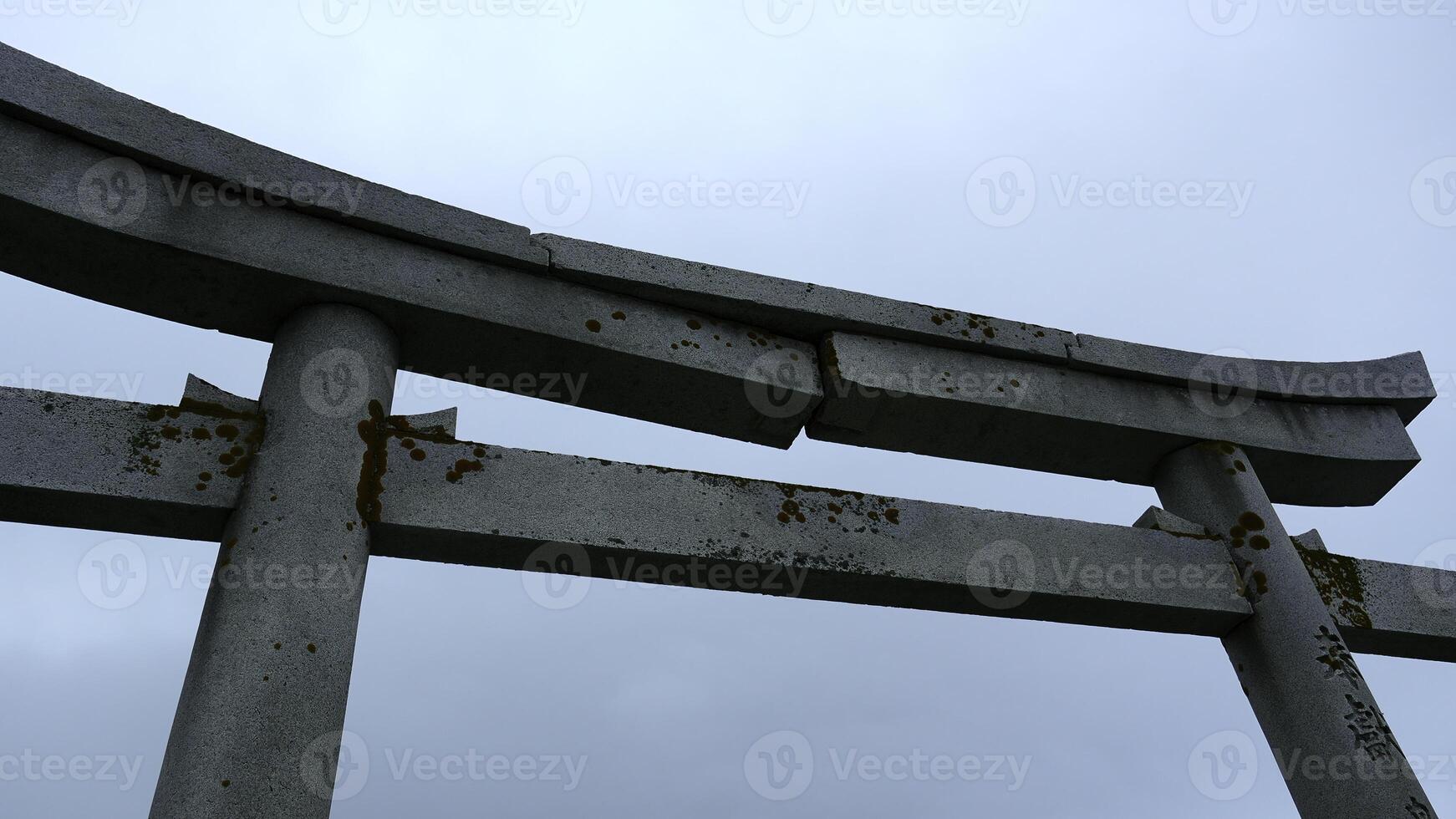 Stone Japanese Arch. Clip. Stone arch in Chinese style on background cloudy sky. Close-up of part of stone arch on background cloudy sky photo