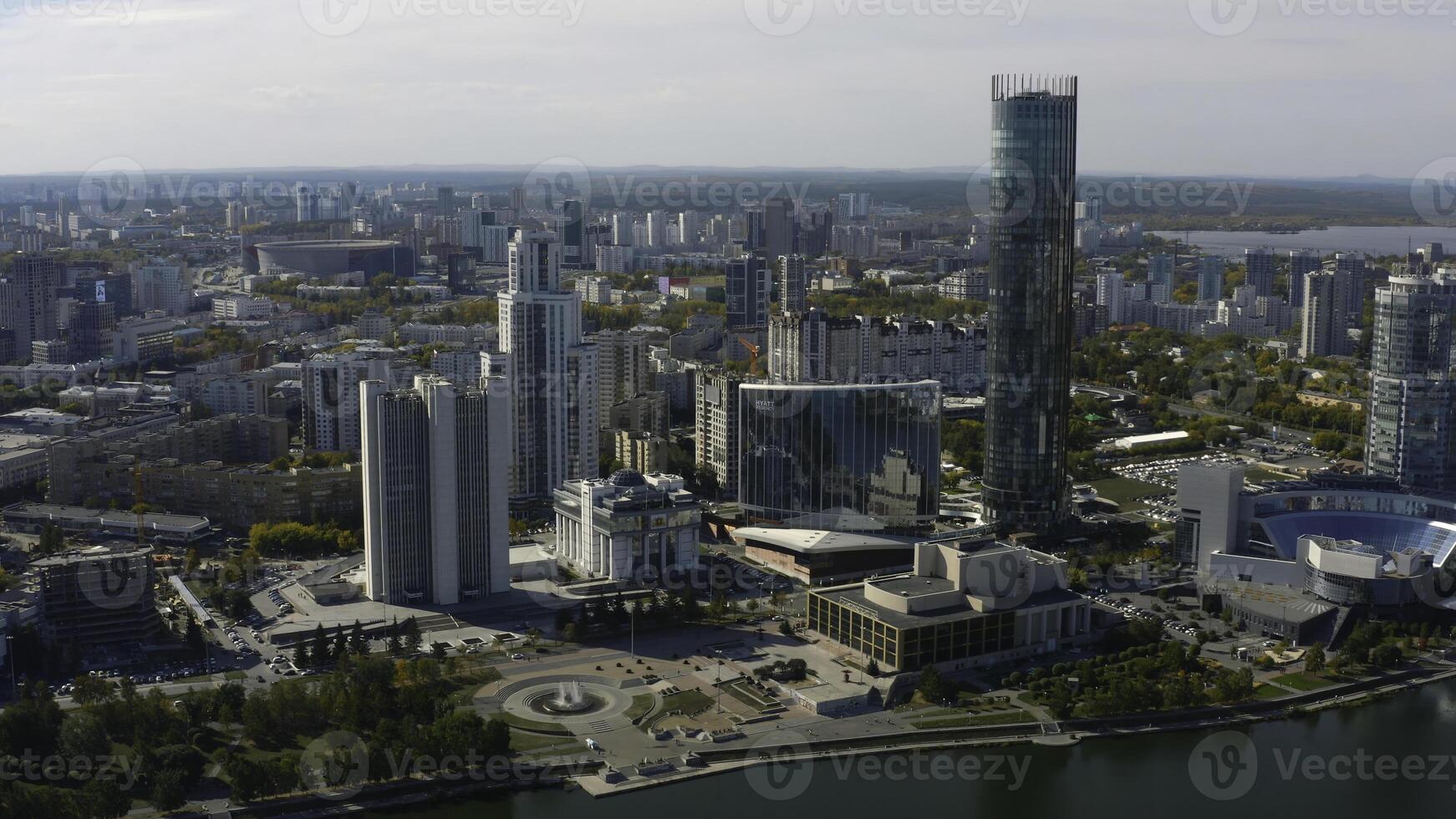 Top view of beautiful modern city with river on sunny day. Stock footage. Beautiful panorama of city with high-rise buildings on sunny summer day. Summer in modern city with skyscrapers and river photo