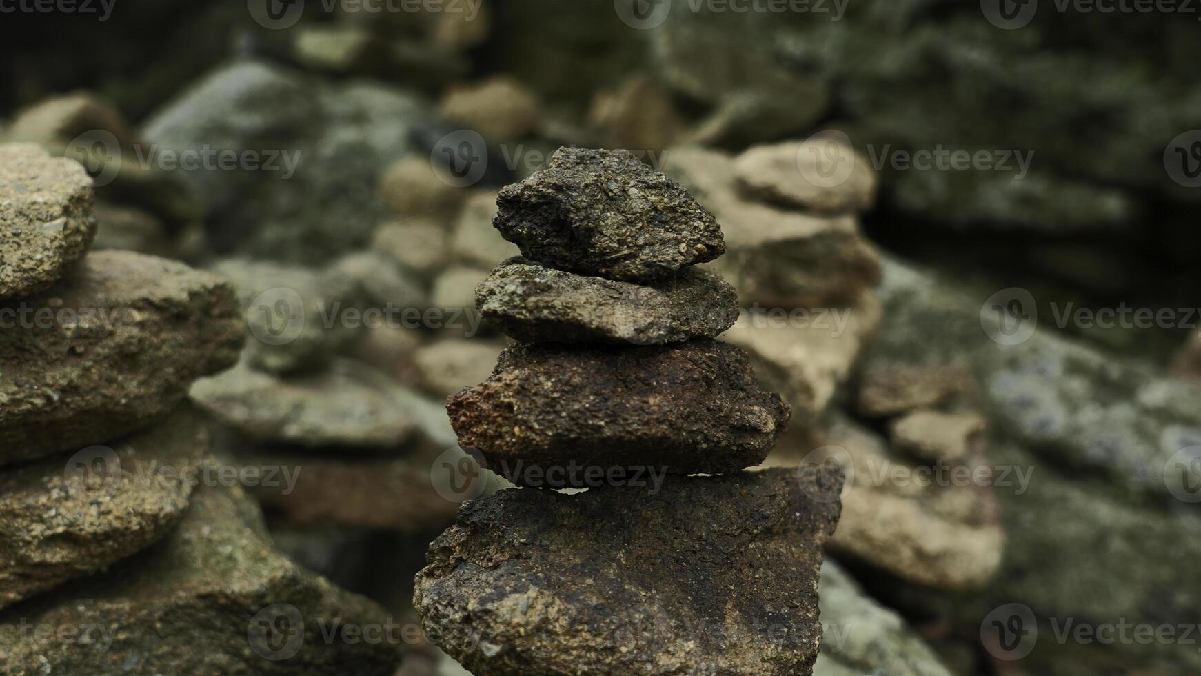 Close-up of stacked towers of stones. Clip. Mountain stones were stacked in turrets. Stacked turrets of rocks on background of rocks photo