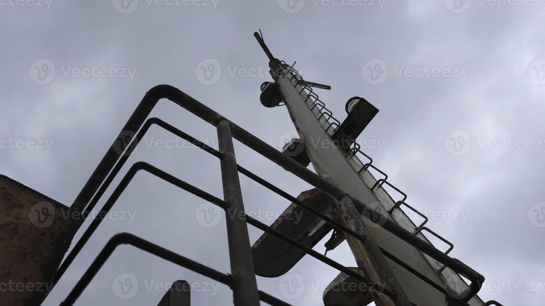 Parts of abandoned fishing boat. Clip. Abandoned boat with rusty parts on cloudy day. Abandoned fishing boat on seashore photo