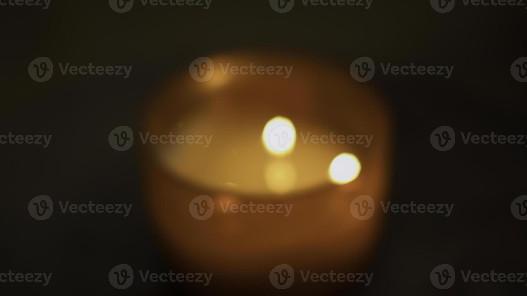 Close-up of flame of cozy candle. Media. Aromatic candle that creates cozy and spa atmosphere. Aroma candle with warm light and fragrance in spa photo