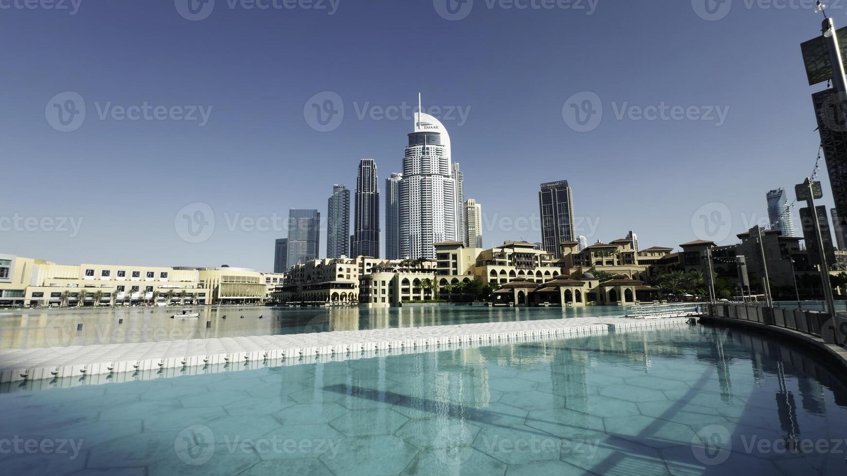 Skyscraper towers and walking unrecognizable crowd of people. Action. Central district of Dubai city. photo