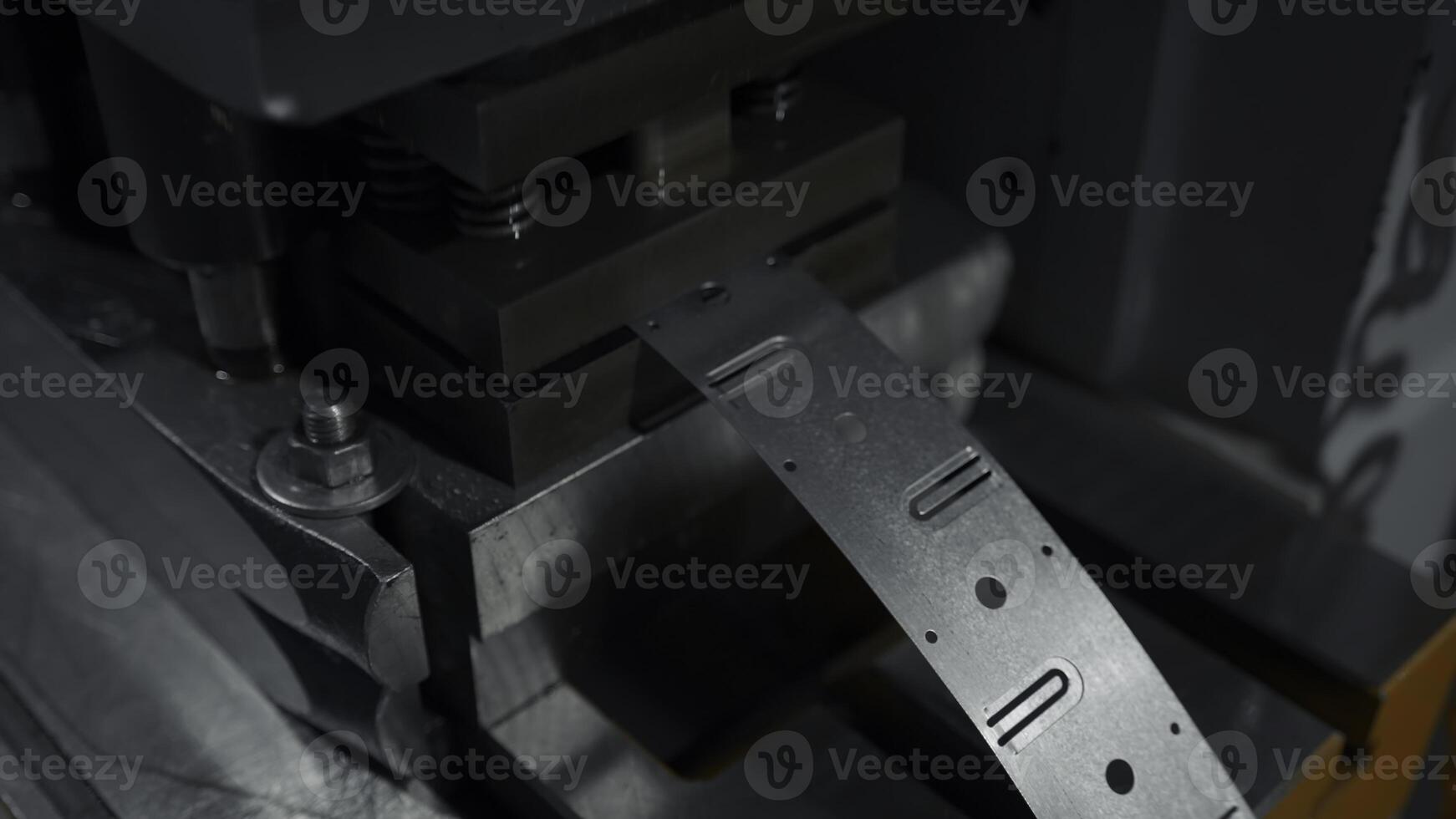 A large industrial punch press forming sheet metal parts. Creative. Close up of sheet metal stamping machine. photo