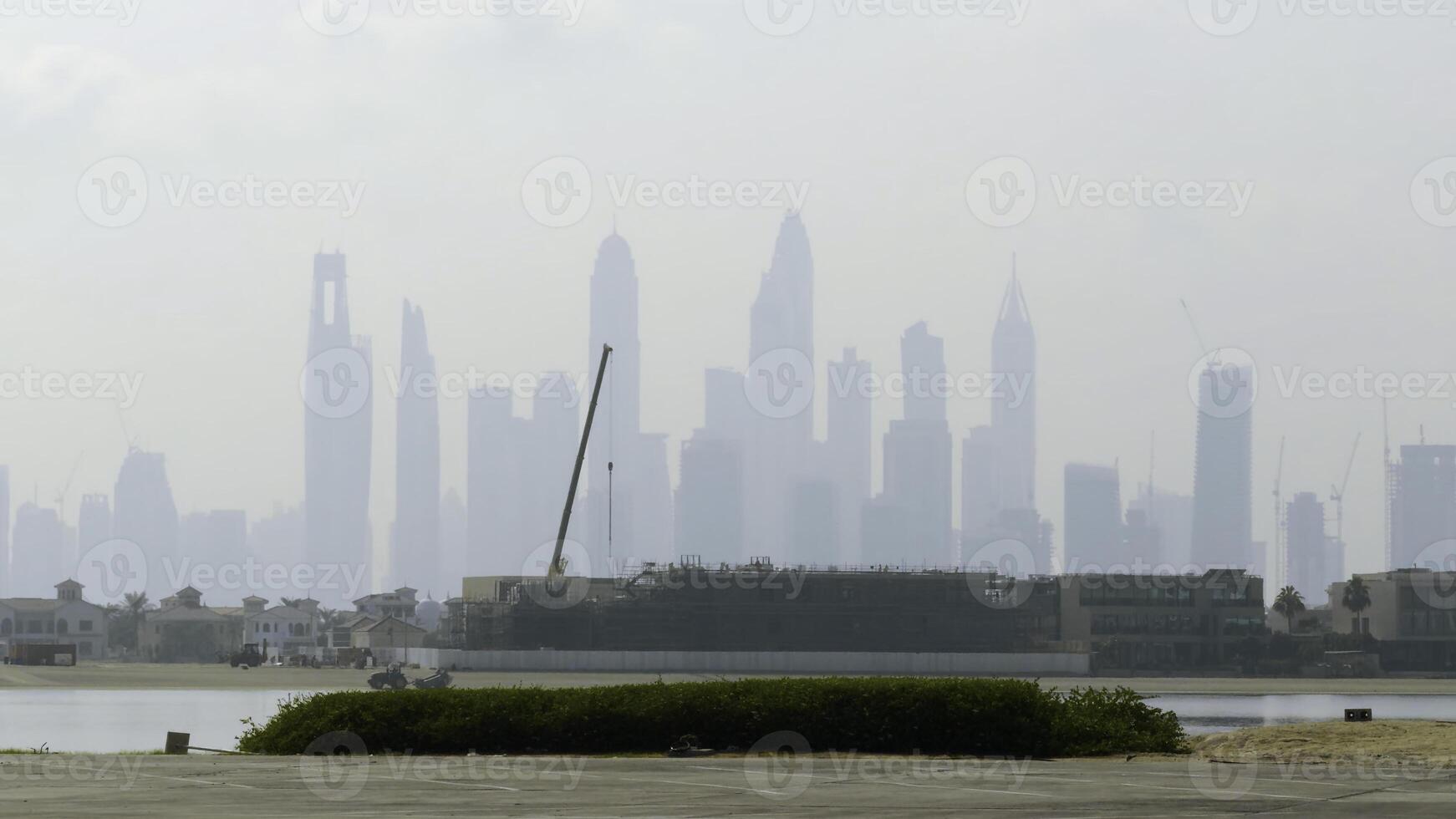 View from the river shore and embankment on skyscrapers in the morning haze. Action. Bi city covered by fog. photo