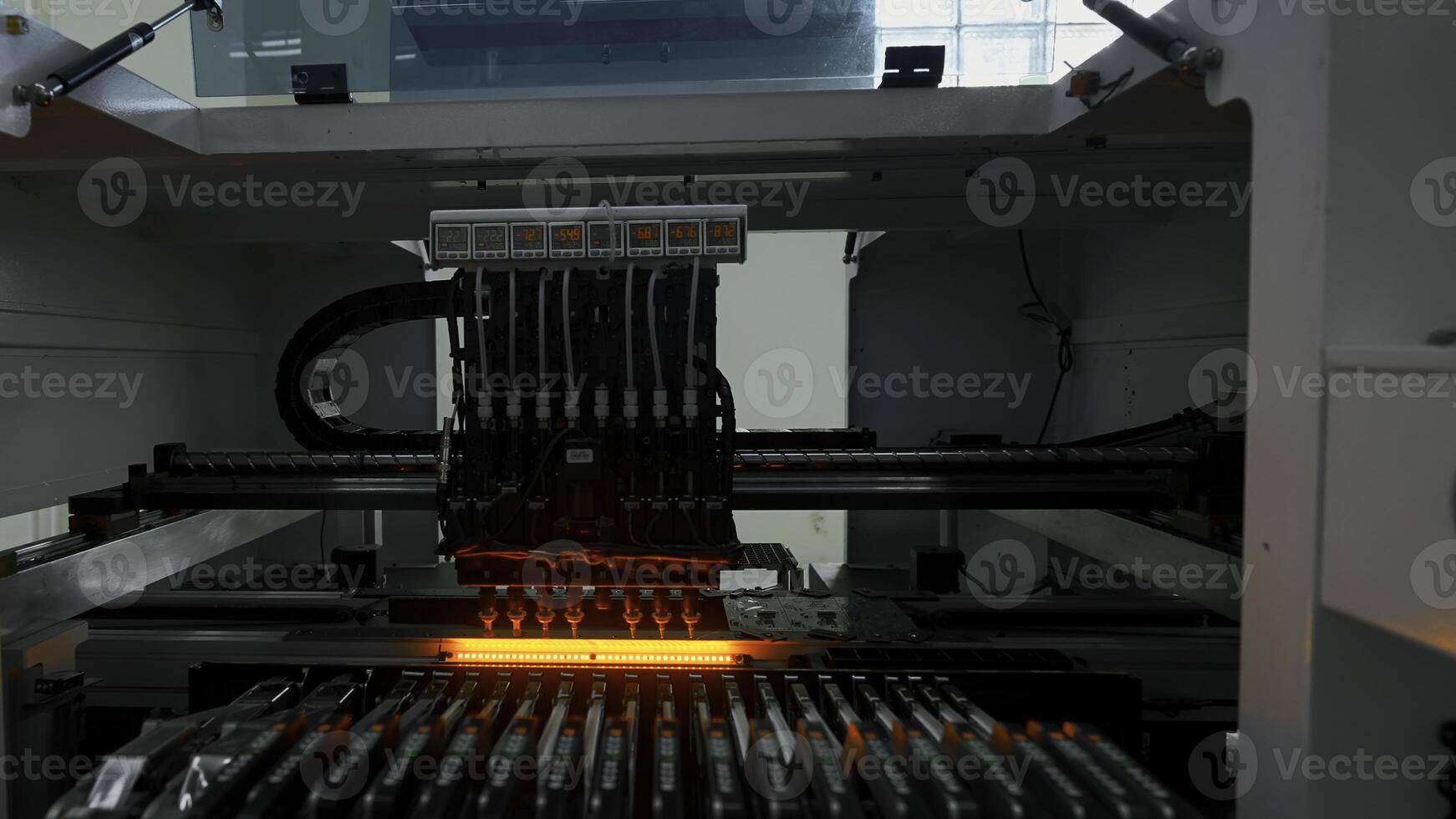 Automatic pick and place machine is installing components on circuit board. Creative. Assembly line on electronics and circuit board manufacturing factory. photo