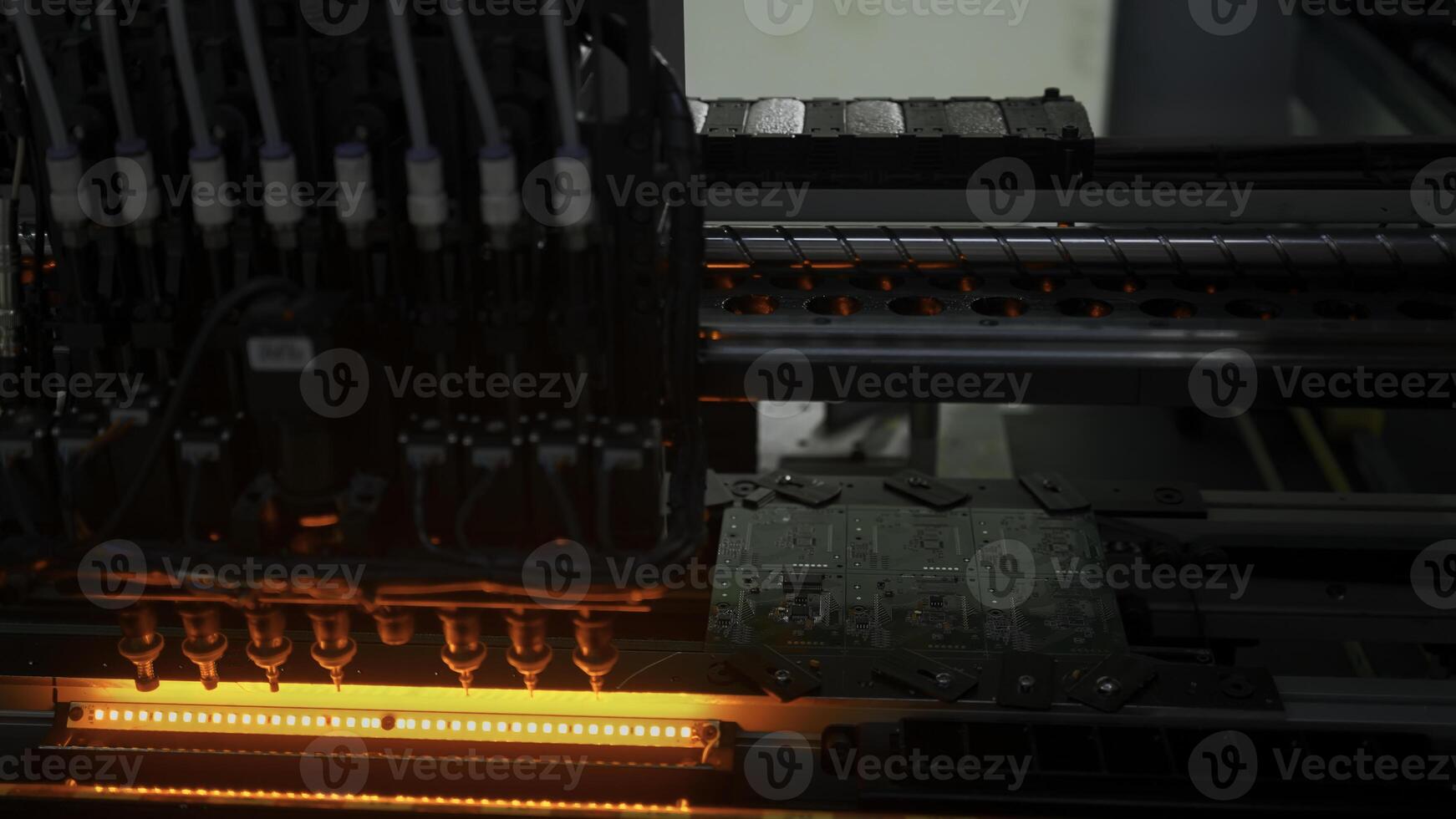 Fully automated assembly line at electronics factory. Creative. Component Installation on circuit board. photo