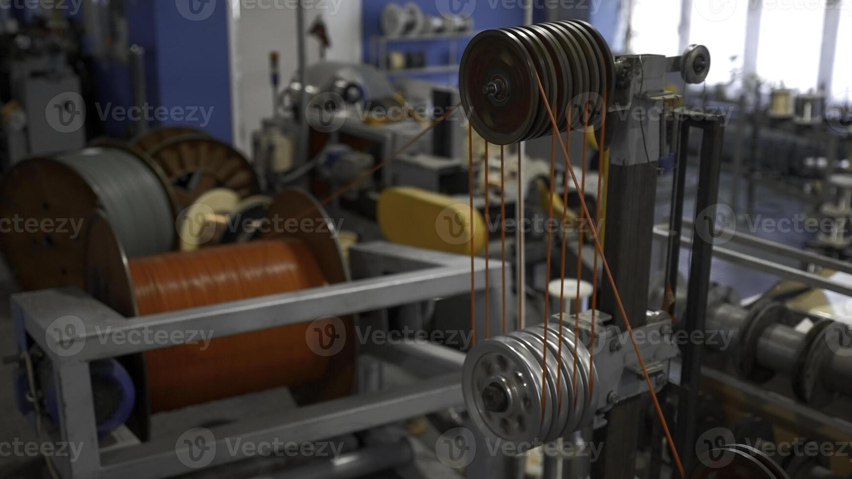 Rotating industrial machine with coils and wires. Creative. Workshop at the industrial plant with spinning machines. photo