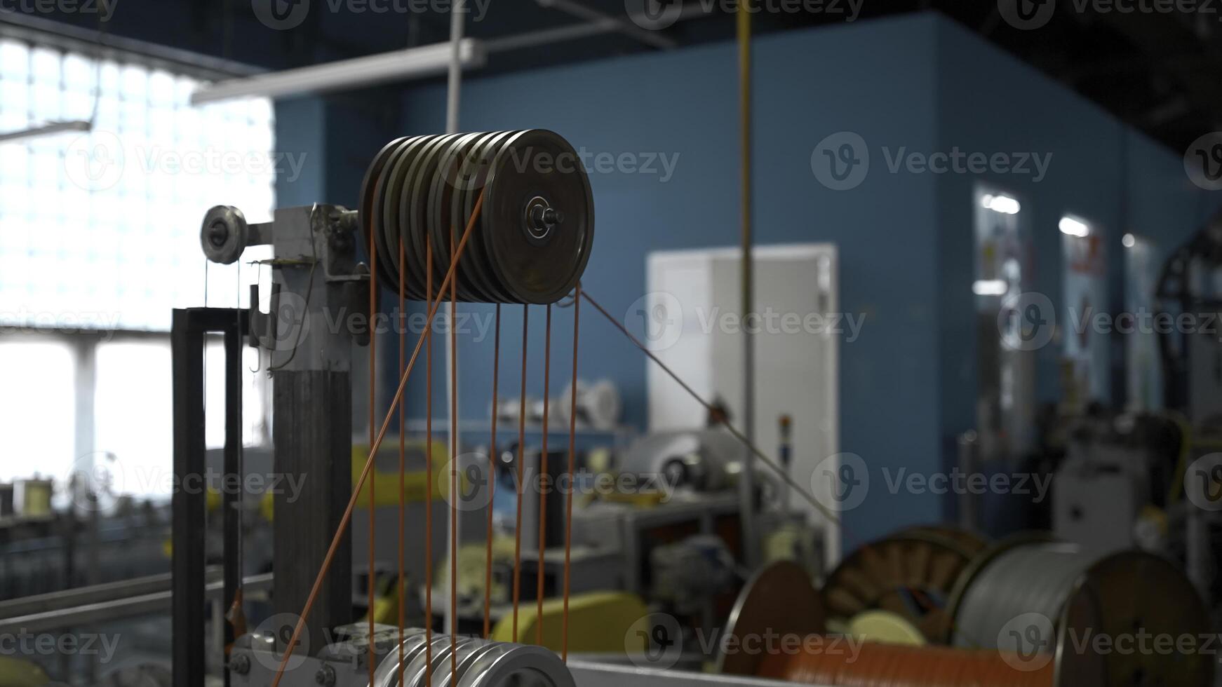 Steel wire coils at a tire factory. Creative. Rotating and reeling metal threads bobbins at modern tire production plant. photo