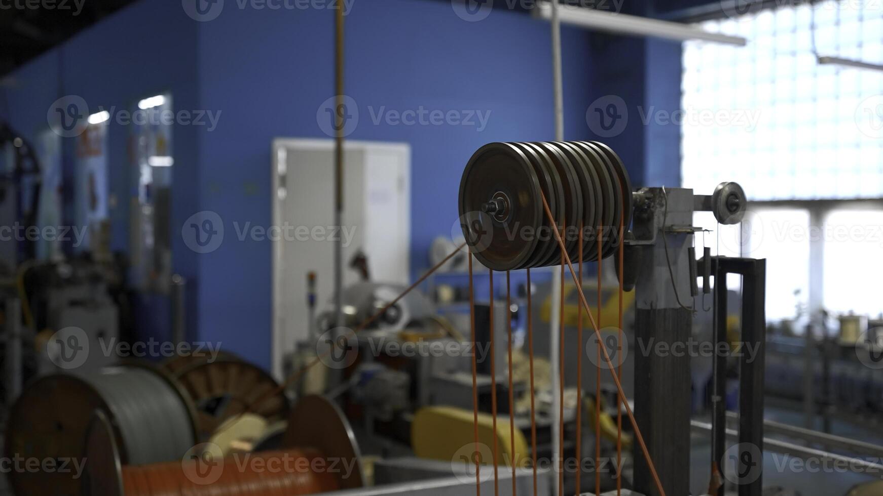 Rotating industrial machine with coils and wires. Creative. Workshop at the industrial plant with spinning machines. photo