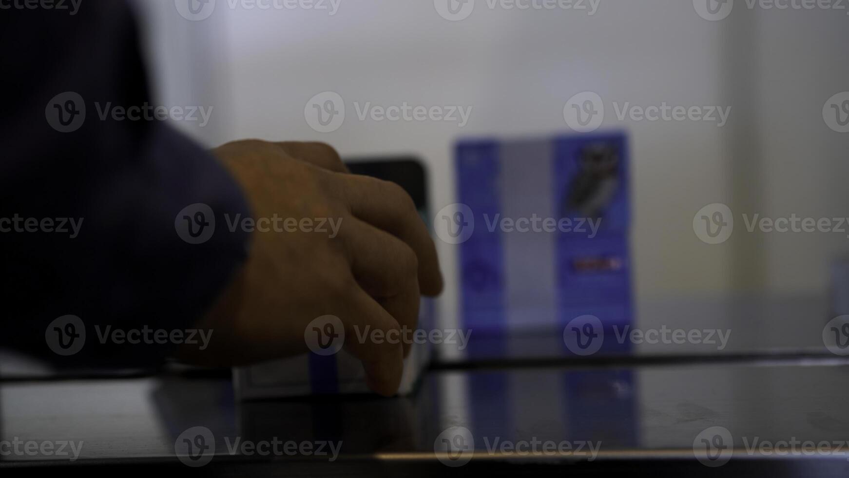 Close up of worker hands finishing the packing of a small cardboard box. Media. Details of post office work. photo