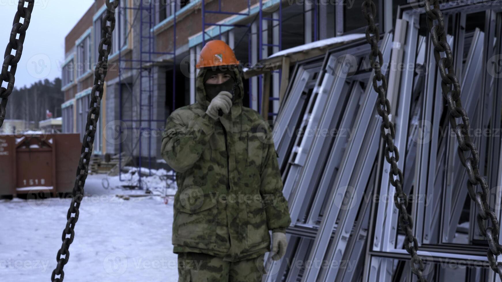 Transporting cement blocks by crane at the construction site. Clip. Builder and industrial background of a building. photo