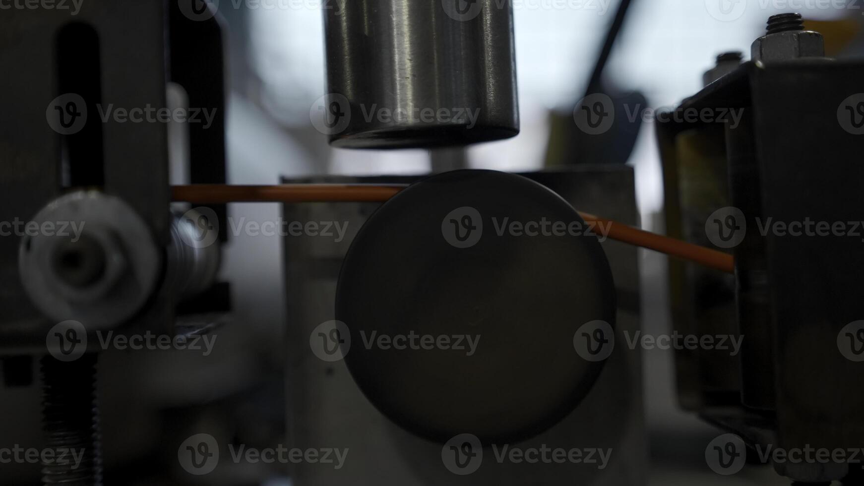 Rotating reels with copper wires on them. Creative. Metal wire spool spinning on the machine. photo