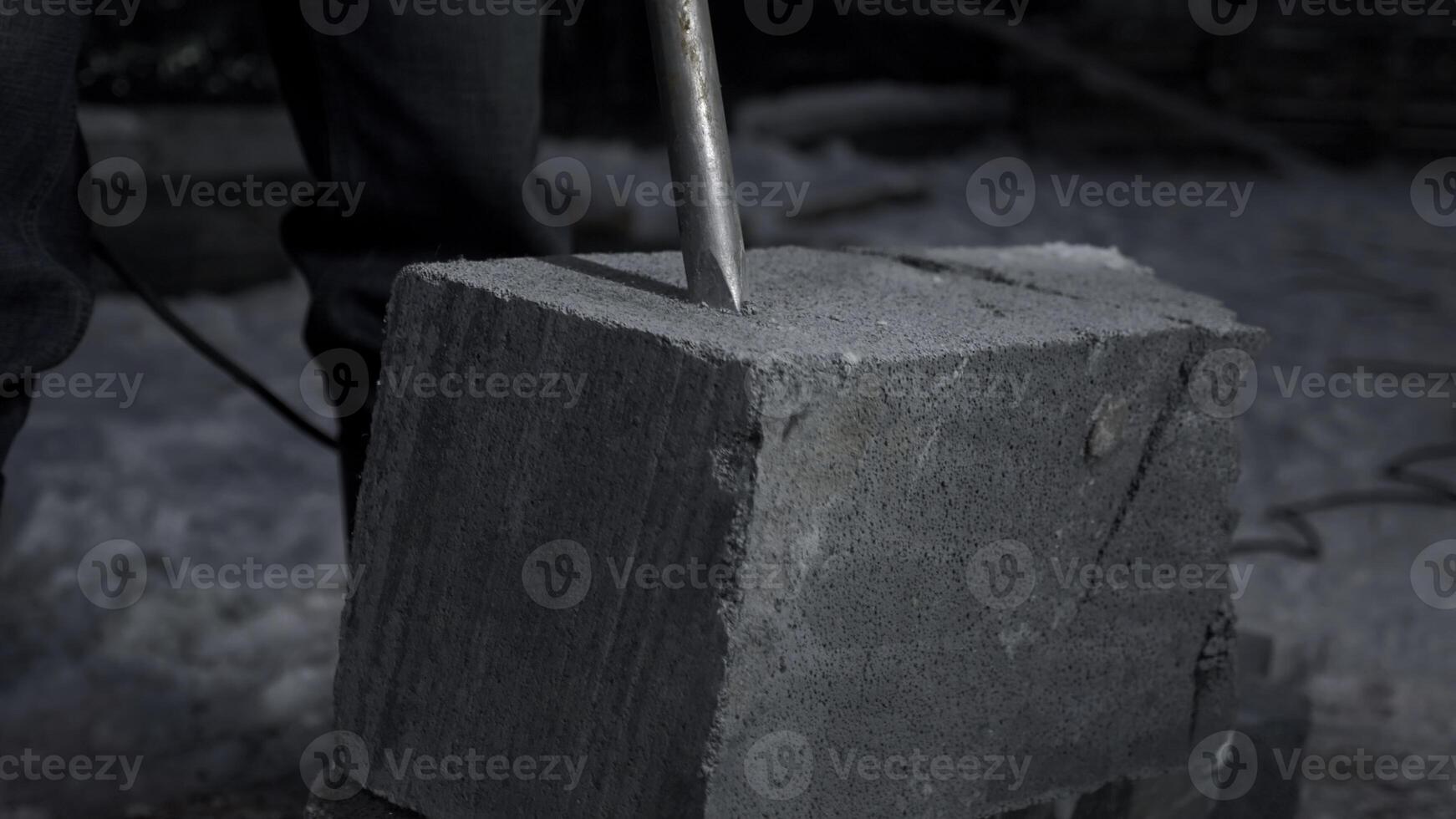 Close up of drilling a cement block. Clip. Industrial works at the construction site. photo